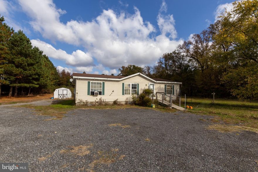 Great investment opportunity! This three bedroom, two bath home features nearly 1100+/- square feet of living space and is situated on an oversized 2.5+/- acre lot surrounded by trees for privacy. A wheelchair ramp at the front door provides easy access to the home and a shed in the rear yard is included. Property being sold AS-IS, WHERE-IS with no guarantees or warranties.