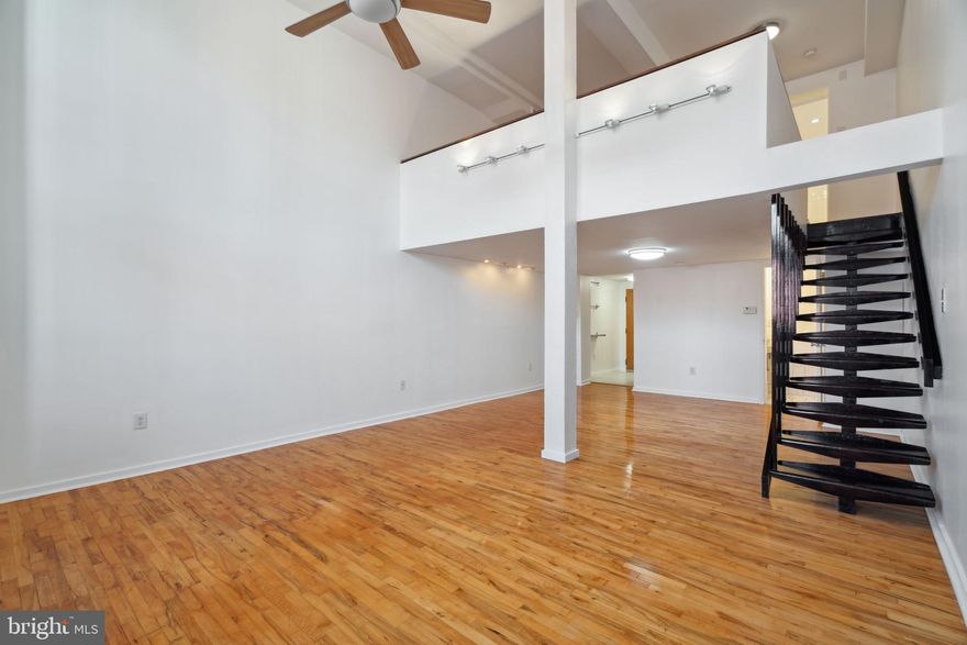 Discover an abundance of natural light in this generously sized bi-level loft condo, featuring 1 bedroom, 1.5 bathrooms, a substantial balcony, and a designated parking space. The living room boasts a vaulted ceiling, while the updated kitchen offers ample cabinet space and a pantry. New porcelain tile and oversized double doors leading to the large balcony accentuate the expansive living area, creating a contemporary loft ambiance. Upstairs, a massive bedroom awaits, complete with a full bath and a conveniently placed walk-in closet equipped with a washer and dryer. Both bathrooms feature tasteful white aesthetics, with the first-floor powder room showcasing unique design elements crafted by a local artist. This pet-friendly building faces the picturesque Palumbo Recreational Park & Playground, and additionally offers interior bike parking and a dedicated storage area in the basement for your convenience. Don't miss this fantastic rental opportunity!