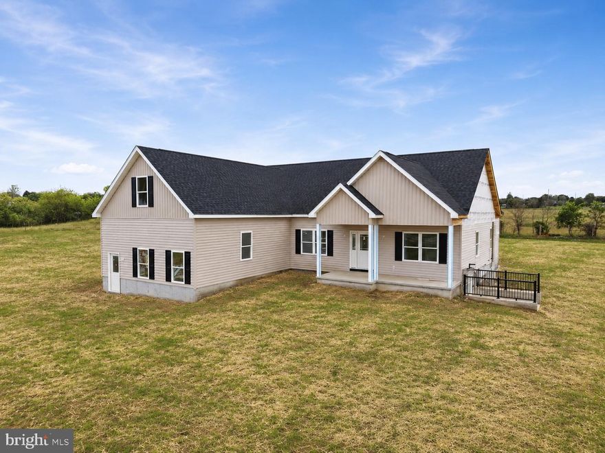 Estimated completion August 2026. Photos shown are of a similar home previously constructed by the builder. Finishes and features may vary.  Welcome to 169 Cather Lane, a spacious rancher situated on 5 beautiful pastoral acres with stunning views and an unbeatable location just minutes from town. Built by local builder Scott & Scott Construction, this home offers the perfect blend of quality craftsmanship, thoughtful design, and peaceful country living. Step through the front door into an open floor plan featuring luxury vinyl plank flooring throughout the main level. Just off the entry, a dedicated office provides the ideal work from home space or flexible bonus room. The kitchen has upgraded cabinetry, an oversized island, and opens seamlessly to the dining and living areas, where vaulted ceilings create a bright and inviting feel. From there, step out to the covered back porch overlooking the backyard, with stairs leading down to the open space behind the home. The owner’s suite features tray ceilings, a walk-in closet, and an en-suite bath with separate vanities. A huge walk-out unfinished basement offers excellent storage and future expansion potential, complete with a rough-in for a bathroom. Conveniently located just 5 minutes from downtown Winchester shopping and restaurants, with state-maintained paved roads all the way to the property. No HOA. Anticipated completion in August. Now is the time to secure the home and lifestyle you’ve been envisioning.