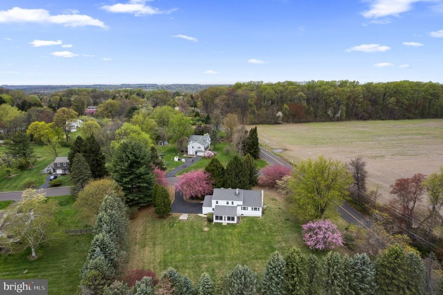 Welcome to this inviting 4-bedroom, 1.5-bathroom split-level home nestled in peaceful and highly desirable Buckingham Township. With 1,890 square feet of thoughtfully designed living space, this property offers the perfect balance of comfort, space, and country charm. Step inside to find a bright and welcoming layout featuring spacious living areas, ideal for both everyday living and entertaining. The main level boasts a comfortable living room, an open dining area, and an updated kitchen just waiting for your personal touch. Upstairs, you’ll find four generously sized bedrooms all with hardwood flooring exposed or underneath the carpeting, and a full bath, providing plenty of room for family, guests, or a home office. The lower level has additional entertaining space with a cozy family room and wood burning stone fireplace, a convenient half bath, and laundry area—perfect for managing daily routines. A two car attached garage offers added convenience and storage space. Behind the family room is a large 21 X 15 screened in porch with views of the backyard. Downstairs is an unfinished and waterproofed basement, great for storage and an exercise space. Additional features include newer windows, roof and siding, 3-zone temperature control, sump pump battery backup, whole home surge protector, and attic fan. Situated on a generous corner lot with scenic surroundings, this home offers the serenity of country living while still being within easy reach of local amenities, schools, and major routes.  You will appreciate the privacy and tranquility this property provides! One year home warranty included.