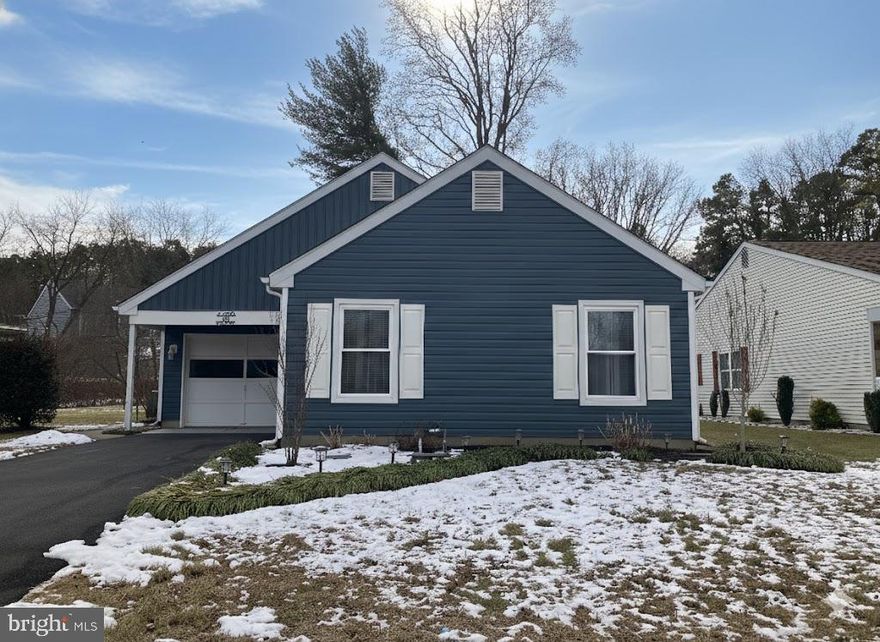 Welcome home to this beautifully updated 2-bedroom, 2-bath Jefferson model offering over 1,500 square feet of comfortable living space. The home features spacious rooms and abundant closet space throughout. Additional highlights include a separate living and dining room, an eat-in kitchen, and a family room with a fireplace—perfect for everyday living and entertaining.  Freshly painted and thoughtfully improved, recent updates include new vinyl siding and gutters, a new hardscaped patio, and a fully renovated main bathroom. The kitchen is enhanced with a new refrigerator and stove, while newer hardwood floors add warmth and style.  Major systems have also been updated, including a newer roof, heat pump, air conditioning system, and hot water heater—providing peace of mind for years to come.  Enjoy the enclosed sunroom with outside access to the private backyard, which backs to a peaceful wooded area, ideal for relaxing year-round.  The home also offers convenient inside access to the large one-car garage.  Additional improvements include added attic insulation and leased solar panels for improved energy efficiency.  Leisuretowne is an active community offering a wide variety of clubs and activities, two clubhouses, pool tables, gyms, libraries, two heated inground pools, picnic areas, and so much more. Ideally located close to Route 70 and Route 206 for easy access to major highways, shopping, and dining. This move-in-ready home is a must-see!