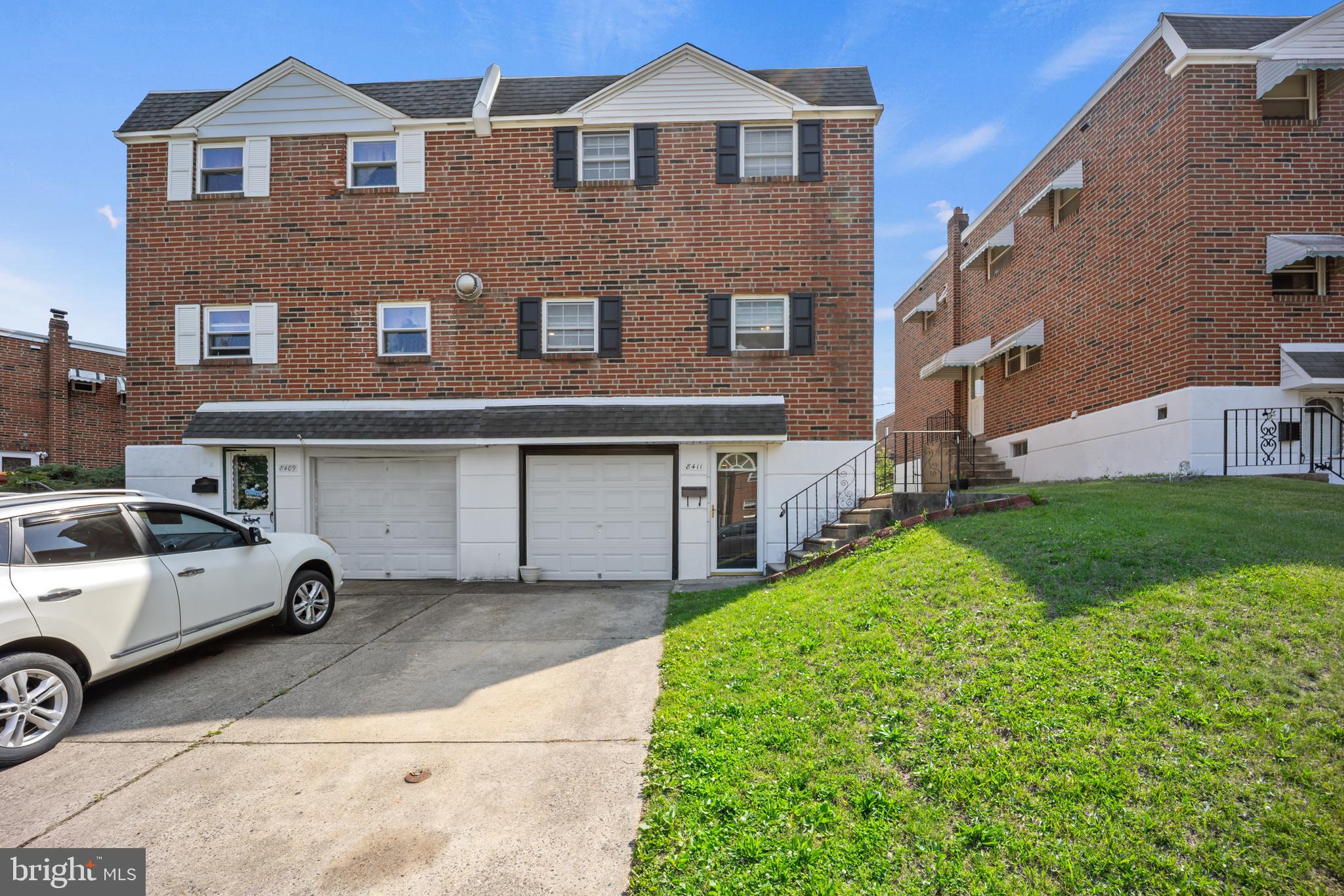 Large brick Twin in a prime location in desirable Fox Chase neighorhood on a Cul-de-sac in walking distance of Penneypack park. Enter through the side entrance main door to an open foyer with tiled floor. Beautiful hardwood parquet floors in huge living room and formal dining room. Large kitchen across the front of home. Plenty of custom cabinets and built in mircowave & dishwasher. Plenty of space for kitchen table for breakfast & informal meals. Large dining room with custom hardwood floors has door with access to powder room on main level and entry to lower level basement. Basement is finished featuring newer custom full bath. Lower level has slider to rear yard. Perfect for inlaw suite or adult children. Stairs to basement may chairlift if needed. Large laundry area with front entry to driveway and inside acccess to oversized one car garage. Stairs from main level to upper level also have chairlift if needed or desired. Good size main bedroom has private full bath & plenty of closet space. There are spilt systems for A/C in 3 upstairs bedrooms. 4th bedroom is currently used as office. There is a full bath in hallway. Good size bedrooms on upper level. Newer vinyl replacement windows throughtout. This is a 4 bedrrom 3 full bath plus powder room on main level. Basement could be inlaw suite or just a great family room for parties with newer full bath on lower level. What a find for a multi-generatioinal family or someone who just desires a large home to live, work & entertain in a great area of Fox Chase on a cul de-sac near parks & shopping.
