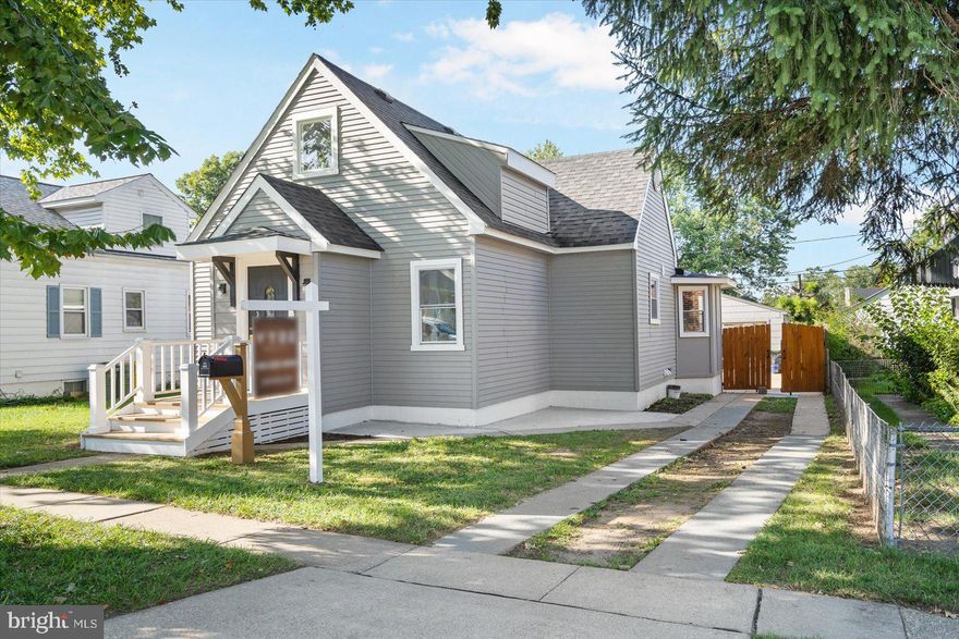 Newly renovated 4BR/3.5BA expanded Cape located on a spacious lot in a desirable neighborhood.  Park just outside the covered entry boasting a newly constructed stairway and open the door into your new home.  Enter into a bright and airy main floor offering an open floor plan, luxury flooring, and a soft color pallet. The spacious living room features a gas burning fireplace on a shiplap feature wall and opens nicely into the dining area and glamorous kitchen. The kitchen is stunning, offering plenty of cabinets, stainless steel appliances including a slide in gas range, quartz countertops with a beautifully tiled backsplash, pendant lighting above the deep sink set into a large island featuring waterfall edges, and lower cabinets with drawers. The dining area is spacious and filled with tons of natural light.  On the main floor is a half bath and a main floor bedroom suite boasting a private full bath with a beautifully tiled walk-in shower. The newly carpeted stairs lead to a primary bedroom suite boasting a large bright room with access to unfinished attic storage, a large closet and a full bath with a beautifully tiled tub/shower.  The lower level features egress windows in the two remaining bedrooms, a full bath with a lovely tiled walk-in shower, laundry, storage, and a walk-out to the fenced yard.  From the main floor step outside to a cozy porch overlooking the spacious yard filled with green space, a large patio, a detached garage with a long driveway to the front. This home is move-in ready with so much to offer new homeowners and is located in close proximity to shopping, restaurants, and commuter routes.