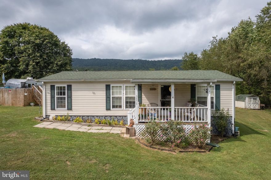 Sellers Motivated!How About An Updated And Well Kept Mobile Home on acreage! In The Mountains Of West Virginia, Close To Morgan County, And Berkeley Springs,  Just A Few Miles From The MD Line! Sellers Currently Commute To Winchester To Work, Overall Easy Commute! 3 Bedrooms And 2 Baths. All On 1 Level. The Kitchen Was Remodeled, New Flooring, Roof Is Newer,. Water Heater Is 3 Years Old! The Above Ground Pool Is Brand New! Outdoor Carport Has Room For 1 Car !
Roomy Laundry Area. Sellers Love This Home And Have Luckily Found Their Dream Home!  Make This One Yours ! 2 Lots Creates This Beautiful Yard, With Open Cleared Space, A Ready Made Garden and Spectacular View! Always Wanted A Garden? Large Open Spacious Lot? Home In The Country? Mountain View? Well, Your In Luck!