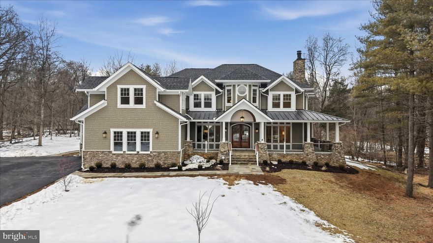 Set on just over 10 private wooded acres, this exceptional new construction estate at 22597 Red Hill Manor delivers a rare blend of architectural detail, refined craftsmanship, and flexible living spaces designed for modern luxury and multi-generational living. The residence offers five bedrooms, six full bathrooms and two half bathrooms, and features five fireplaces thoughtfully placed throughout the home, including the great room, living room, hearth/keeping room, primary suite, and lower level living areas.

The main level is defined by soaring ceilings, wide-plank hardwood sand in place flooring, and extensive custom millwork, creating a seamless flow between formal and informal spaces. The kitchen is a true centerpiece, with a massive center island and outfitted with a premium Sub-Zero, Wolf, and Cove appliance package, including professional-grade cooking, built-in refrigeration, wall oven, microwave, and paneled dishwashers. A fully equipped scullery and walk-in pantry extend the kitchen’s functionality with additional refrigeration, beverage storage, and prep space, while a dedicated coffee bar and butler’s area elevate everyday convenience. A private main-level office with its own exterior entrance and custom cabinetry and wet bar offers outstanding flexibility for professional use or a quiet retreat.  The main level is equipped with a massive laundry area with plenty of custom cabinetry and counter space.  An additional laundry room is located on the second level for convenience.

The upper level features generously sized secondary bedrooms, all finished with curated tile selections, custom cabinetry, and designer fixtures. The primary suite serves as a private sanctuary, highlighted by a sitting area, gas fireplace, spa-inspired bath with soaking tub and oversized walk-in shower, and a custom tailored closet.

The lower level is designed as a true extension of the living space, offering a large recreation and family room, wet bar, wine cellar, and multiple specialty areas. A large bedroom or recreation suite with a full bath provides ideal accommodations for guests or multi-generational living. Wellness features include a sauna and steam shower and an additional full spa bathroom with a steam shower and double vanities, while additional fireplaces and walk-out access enhance comfort and usability.

Outdoor living is equally impressive, featuring a large Trex deck with Trex railing system and a stamped concrete patio, creating multiple spaces for entertaining and relaxation. The exterior architecture is distinguished by extensive custom stonework, including stone façade elements, flagstone walkways, and thoughtfully designed hardscaping that complements the natural setting. The home is clad in HardiePlank siding with multiple textures, adding depth, durability, and visual interest to the exterior design. A three-car garage includes a custom dog wash station, combining practicality with thoughtful luxury.

Throughout the home, carefully selected finishes and materials reflect a cohesive design vision, including custom cabinetry, quartz and quartzite countertops, designer lighting, specialty tile installations, and detailed trim work.