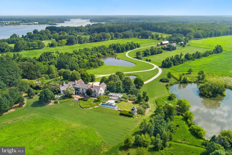 Hartwell Estate features 80 private acres with pristine, panoramic views on the mouth of the Langford and Chester River.  This light filled custom built home and property captures the essence of serene living on Maryland's Eastern Shore. One of only 4 premiere properties at the end of Quaker Neck, often called "Kent County's Gold Coast"  is sited to take advantage of the natural landscape with expansive views of the river, the owners' goal was to retain the feel and function of a working farm, but to add a modern house inspired by Maryland's historic heritage. The residence succeeds as a home for family comfort, entertaining, relaxing, gardening, hunting, fishing, birding and appreciating wildlife. Its east/west orientation highlights sunrises and sunsets that can be enjoyed from every room in the house. A real retreat.
The five bedroom and 7 fireplace (woodburning) home was designed with 12-foot ceilings on the first floor to accentuate the views and the light. A main floor primary suite includes two separate ensuite dressing rooms and bathrooms along with a wood burning fireplace. The second floor has four bedrooms, three with fireplaces, and all with ensuite bathrooms. One bedroom has a separate sitting room. A wide hall runs along the width of the house providing access to all of the rooms.
The property features the landscape design of acclaimed D.C. based Oehme, van Sweden. Hardscapes and plantings were strategically orchestrated and include a walled garden filled with flowering trees and shrubs along with a sweep of peonies in the spring. Three ponds invite active wildlife, including a beautiful blue heron. 50 acres of fields are currently being organically farmed by a neighboring farmer.  An additional 3 bedroom and 2 bath cottage (c 2012), adjacent to a barn and silo, currently occupied by a caretaker, is situated near the property entrance. Two covered structures within the walled garden provide a relaxing reading or meditation venue. Bluestone and brick terraces along the entire river facing side of the house lead to a pool and pool pagoda.
The property is uniquely designed to capture the feeling of the land while being welcoming and inviting to all who live there or visit. It has been lived in and loved by the original owner for over two decades. Family hunting and fishing are exceptional. Rock Fish is plentiful. The main residence has recently benefited from a new cedar shake roof and updated energy efficient French doors and windows throughout. The unfinished basement is approx. 2900 square feet with 9' ceilings, inviting the next steward to introduce additional lifestyle enhancements.
Less than 10 miles to downtown Chestertown, with its restaurants, coffee shops, food stores, bookstore and vibrant music and art scene, this property combines riverfront tranquility with easy access to town. 
Additional FAQ:  2013-caretaker house built; 2020 small pond redesigned and landscaped; 2021 new cedar shake roof installed, copper gutters and downspouts repaired as needed; 2022 all windows and French doors on main level replaced with top of line Anderson product- trim removed, replaced and painted; 3 lintels in walled garden replaced with black walnut; 2024 resurfaced entire lane from Lands End Road to main residence; all windows and French doors on 2nd level replaced; farm buildings painted.
Property access is restricted to scheduled appointments only.