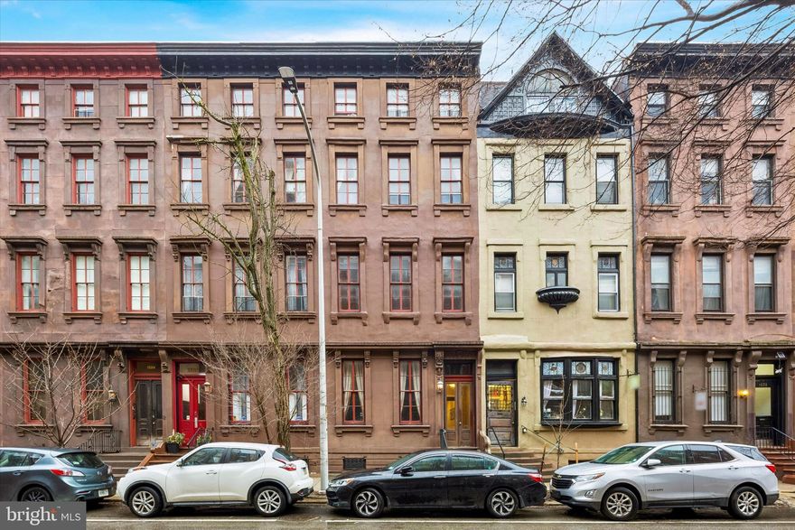 Nestled within an iconic 1862 Victorian brownstone, this exquisite second-floor residence offers a rare opportunity to own a piece of Philadelphia’s architectural history—seamlessly reimagined for modern living. Positioned above the street, the home captures serene treetop views along with glimpses of the city skyline and surrounding historic facades, creating a quiet, refined escape in the heart of Rittenhouse.

Inside, the residence unfolds into a light-filled living space where historic elegance takes center stage. Soaring 11’10” ceilings, original plaster moldings, and oversized windows evoke a sense of grandeur, while rich hardwood floors and recessed lighting provide a sophisticated, contemporary balance.

The kitchen is both functional and beautifully appointed, designed for effortless entertaining. A generous granite breakfast bar anchors the space, complemented by custom maple cabinetry, stainless steel appliances, a 4-burner gas range, and a built-in wine cooler—perfect for intimate evenings or hosting guests in style.

The bedroom suite offers a tranquil retreat, complete with a ceiling fan, custom closet storage, and a well-appointed ensuite bath featuring a full tub and shower. A discreet in-unit washer and dryer enhance everyday convenience without compromising the home’s clean aesthetic.

Additional features include private basement storage, classic radiator heat, and dual mini-split systems for efficient, customizable climate control.

Residents enjoy a low monthly condo fee that includes heat and water, no capital contribution, and a pet-friendly building—an increasingly rare combination in this coveted neighborhood.

Just outside your door, Rittenhouse Square delivers the very best of city living—renowned dining, boutique shopping along Walnut Street, the beloved farmers market, and cultural destinations all within a short stroll.

Properties of this caliber, in a location this iconic, at this price point, are becoming exceedingly scarce. This is more than a home—it’s a chance to secure a timeless address in one of Philadelphia’s most sought-after neighborhoods before the opportunity disappears.  Schedule a showing today!