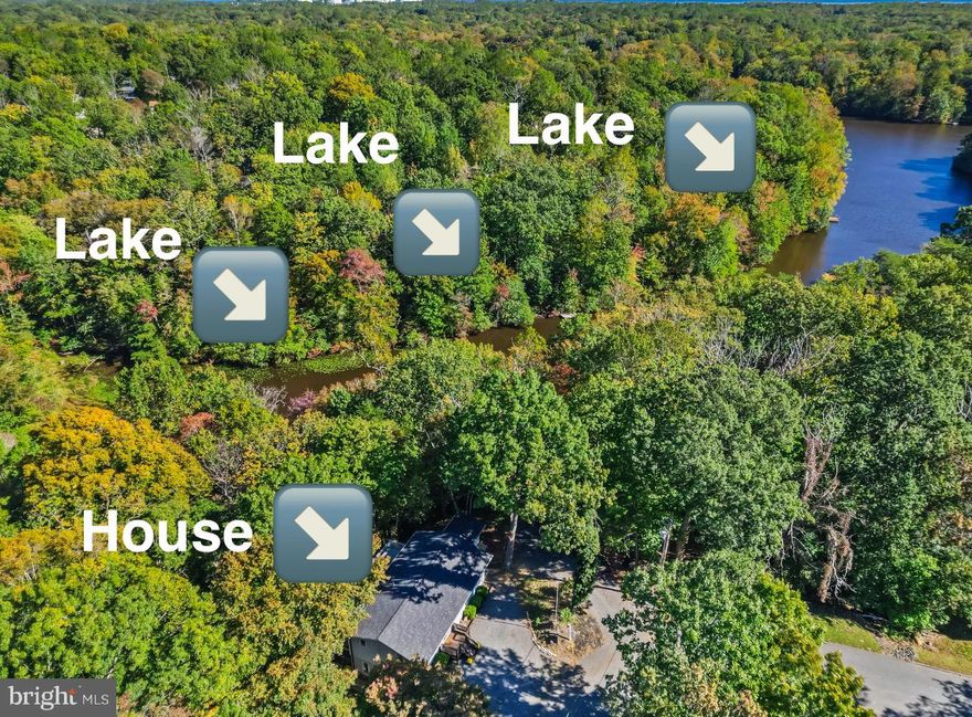 Enjoy living on over one acre of wooded property on Lake Lariat!   Brand new septic just installed gives peace of mind for years to come.   Two finished levels of  indoor and outdoor living space gives you plenty of room to relax.   Main level features a hardwood entry way with living room open to dining room  and kitchen with butcher block counters, updated appliances, and plenty of cabinet space.  Homeowners will love the private retreat of the primary bedroom with private bathroom, slider leading to deck with hot tub.  Two additional bedrooms and full hall bath round out this level.   Slider located off the kitchen  will take you out to a two level deck overlooking the woods and the lake.  Peaceful living at last!
You'll get double the living space here with the  finished lower level.  Spacious family room, pellet stove, bar area,  sound room (time to start that podcast!) , laundry room , half bath and storage.  
Multiple exits open onto the covered lower deck that spans the entire length of the home—an entertainer’s dream space. Out front you’ll find plenty of parking with circular driveway plus a storage shed.   Located in a Chesapeake Bay waterfront community, residents enjoy access to three sandy beaches—two on the Bay and one on Lake Lariat—along with all the dining, shopping, and entertainment that  near by Solomon’s Island has to offer. Convenient commute to Cove Point LNG, Calvert Cliffs, and PAX Naval Air Station.  Easy to show, come see it today!