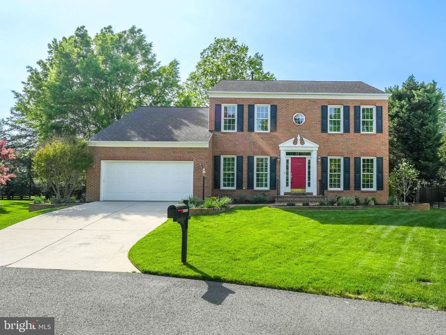 Perfectly placed in a horseshoe cul-de-sac with a deep & private yard this NV built, expanded Chapel Hill model is a classically beautiful red brick colonial with black shutters and brick walkway. Facing open and manicured greenspace with tree preservation just across the street, this home is uniquely private yet favorably placed just a stone’s throw from Tall Cedars Pkwy with quick access to Rte 50 & major commuter routes.
Pride of home ownership and good living stream from every corner of this stunning home. Triple crown molding throughout the main level, solid hardwood floors and exquisitely renovated custom kitchen with large island. Shaker-style cabinetry with oversized drawers and designer hardware gives this a truly custom and luxurious feel.  Freshly painted from tip to toe with new door hardware, new designer light fixtures and ceiling fans throughout, and new electrical outlets and switches.  New carpeting on all three levels and new porcelain and ceramic tilework in the kitchen, laundry room, and bathrooms. Solid hardwood floors newly refinished in Weathered Oak. This central and spacious kitchen is the heart of the home,e with kitchen table space that spills into the great room with cathedral ceilings and marble surround fireplace. The huge sunroom with 3 sets of glass paned French doors invites light and warmth into this beautiful floorplan.
Upstairs, the primary bathroom artfully renovated and upgraded with designer fixtures & hardware. Standalone soaking tub and huge walk-in shower with gorgeous, designer tilework.  3 additional bedrooms, generously sized, and a second renovated bathroom complete the upper-level living space.
Spacious and open lower level with full bath, bonus den/room and walk-up stairs to rear deck is versatile space with endless opportunities.  Enormous, unfinished storage area is a 28’ x 20’ ft bonus area for all of your needs.
In the heart of South Riding, a neighborhood renowned for its community and neighbor-oriented activities, tree-lined streets where neighbors meet on the Town Green for ice cream and summer concerts & movies. 4 community pools, clubhouses, fitness center, party room, pier & fishing dock, ponds and picnic areas, tennis, basketball, pickleball & volleyball courts, dog park, walking trails, and mountain bike trails. With shops, restaurants, and all conveniences at your fingertips, close to Dulles airport, major commuter routes, and 20 minutes to the Metro Silver Line. Don’t miss out on this exceptional home in Loudoun’s premier neighborhood!