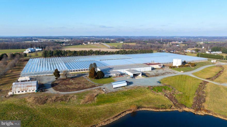 34+ Acre Greenhouse & Agricultural Facility

Exceptional opportunity to acquire a large greenhouse operation on 34+ acres. Features include 14.4 acres of glass and poly greenhouses, a 56,050 sq. ft. warehouse with floor heat, and 2,450 sq. ft. of office space with central air. The facility is equipped with advanced Piva environmental controls, automated heating and watering systems, and is powered by two 400 HP Superior boilers, supported by an SR64 Caterpillar backup generator. Water supply is abundant with a 7,000,000-gallon pond, large pump house, and three backup wells (40 GPM each). Conveniently located along MD Rt. 264 and just 5 minutes from I-95.
