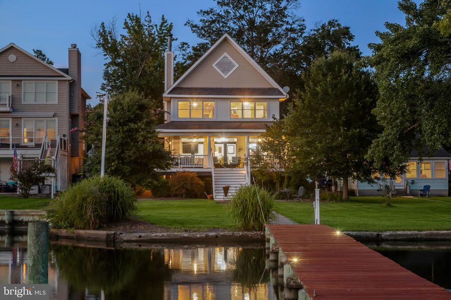 If you’ve ever dreamed of waterfront living, 824 Seneca Park Road makes it a reality.
This 4-bedroom, 3-bath home welcomes you with a thoughtfully landscaped lawn and a sweeping wraparound porch that captures stunning views of Seneca Creek. Inside, the open floor plan begins with a pillared entry to the spacious living room, where a cozy wood-burning stove and easy access to the porch create a warm, inviting atmosphere. The adjoining dining area shares the same peaceful water views, setting the stage for gatherings both large and small.
The gourmet eat-in kitchen combines style and function with custom hickory cabinetry, stainless steel appliances, including a new oven (2025) and dishwasher (2022), and quartz countertops (2022). A striking 11-foot center island with a wet sink, wall oven, and planning station anchors the space, while skylights bathe the room in natural light.
Convenience meets comfort on the main level with a bedroom, a full bath, and a fully finished laundry room. Upstairs, the primary suite is a true retreat. A sitting room surrounded by windows offers sweeping views of your 190-foot pier, while double entry doors lead into the suite itself, featuring two walk-in closets and a spa-inspired bath with new vanities, a Jacuzzi tub, glass-enclosed shower with designer tile, and a private water closet. Two additional bedrooms connected by a dual-entry bath complete the upper level.
Outdoor living shines here. The private pier, refinished along with the deck in 2025, features a boat lift accommodating up to 8,000 lbs. and a MLW of approximately 8’, all with coveted southwest exposure. The detached garage with electric service includes a workshop and an unfinished loft with sewage hook-up, perfect for a future studio, office, or guest suite. A brand-new asphalt driveway (2025) completes the property.
Located close to I-95, shopping, and dining, this home places you in the heart of the Bowleys Quarters lifestyle, where local seafood restaurants, Bengie’s Drive-In Theatre, and the Middle River Lighted Boat Parade are just minutes away.
This home truly has it all; waterfront living at its best with modern comfort and convenience.