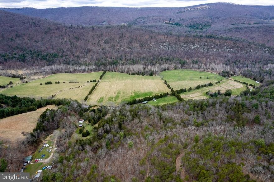 Own your own slice of "Almost Heaven, West Virginia." The perfect hunter's paradise awaits! This fabulous property has it all. Over 200 acres offers woodlands for amazing hunting that borders National Forest, over 20 acres in crop/hay/pasture, full time creek & stream, plenty of trails for your ATV. Enjoy the benefits and fun of two streams: Kettle Creek runs through the property between the hay field and the wooded slope.  House is great fixer upper or hunting camp with gas stove, refrigerator, microwave, wood heat, minimal electric, no septic, well that is not in use (not deep/contains minerals), 5 bedrooms and more! Plenty of pasture for any livestock or farm animals you desire.  Located near Potomac Valley Overlook. High speed internet available.