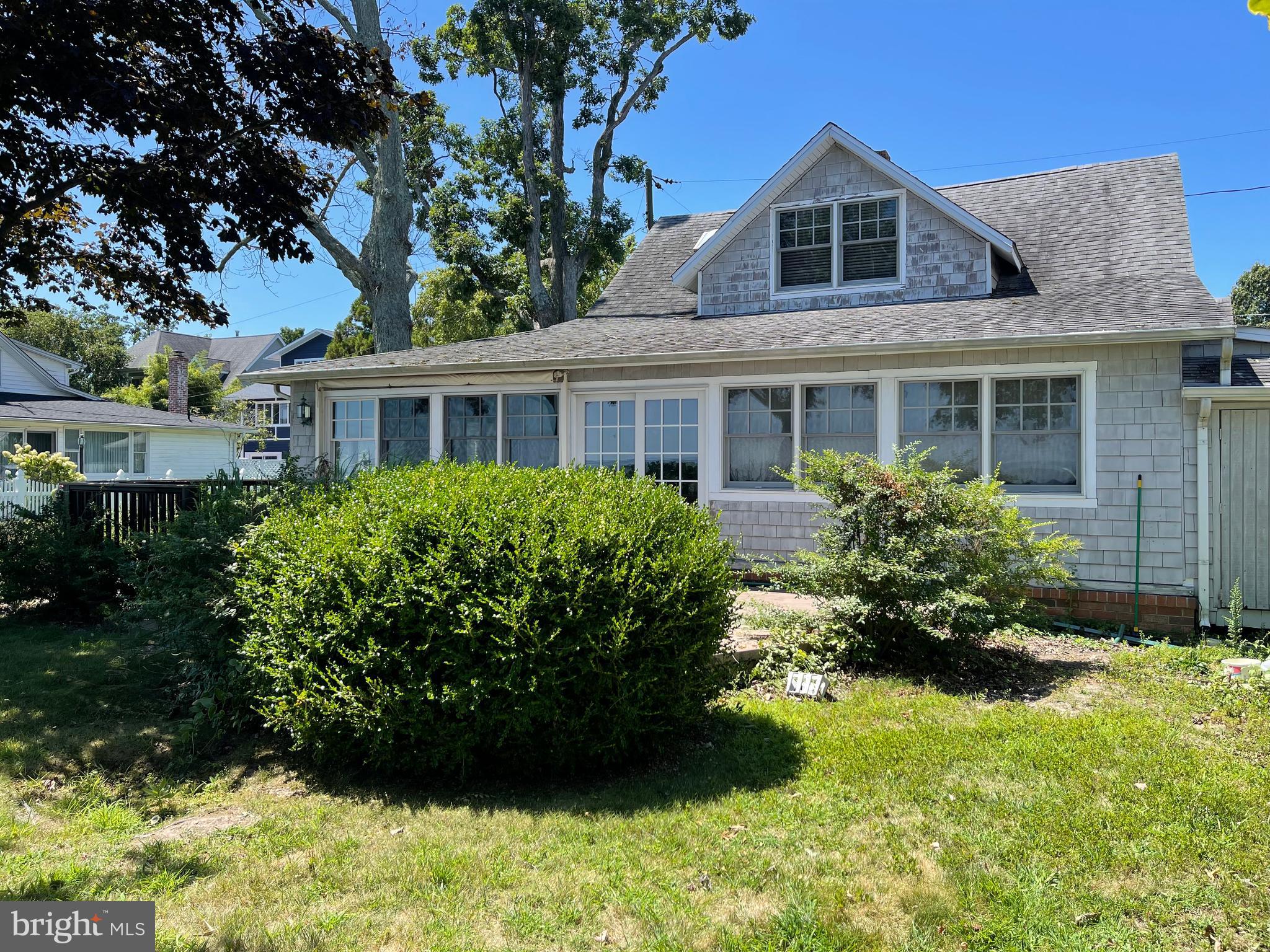 Rare Chesapeake Bay waterfront property with panoramic views and endless potential! This 3-bedroom, 2-bath home sits on a prime waterfront lot with a private pier, spacious yard, and mature landscaping. Enjoy sweeping Bay views from the sunroom, living room, and multiple bedrooms, along with the soothing sounds of the water just steps away.
The home features charming wood ceilings, exposed beams, a cozy brick fireplace, and large windows that bring the outdoors in. A bright kitchen with stainless steel appliances opens to casual dining and living spaces, perfect for gatherings. The lot offers space for outdoor entertaining, gardening, or creating your dream waterfront retreat.
Whether you renovate the existing home or build new, the value here is in the land and the unmatched location. Imagine morning coffee on the deck, afternoons fishing or crabbing from your pier, and evenings watching the sun set over the Bay. Opportunities like this don’t come often — seize your chance to own one of the area’s most desirable waterfront addresses. Estate Sale, Sold As-Is.