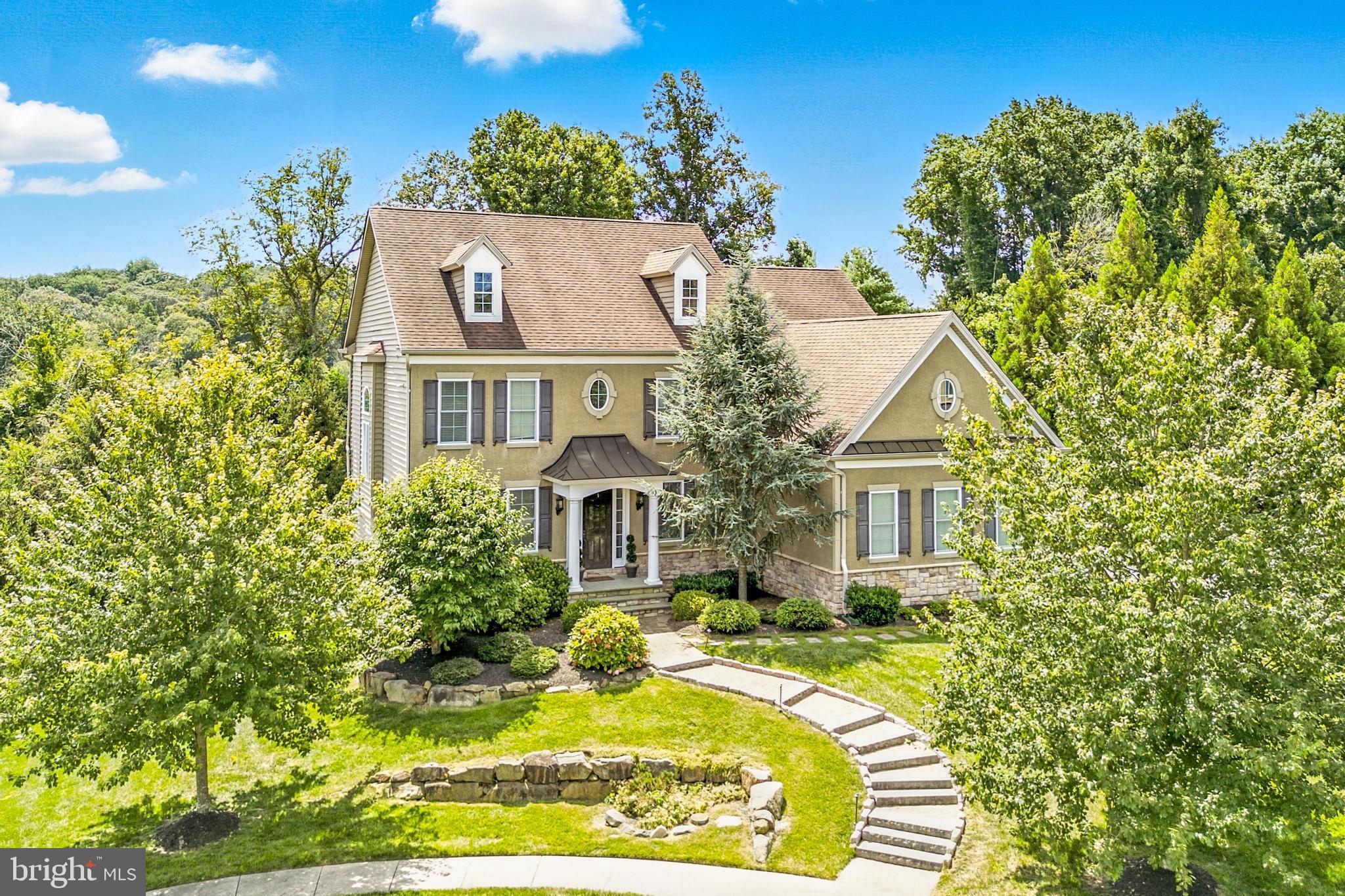 Welcome to 24 Oakmont, located in the rarely available Pine Valley neighborhood within the award-winning Garnet Valley School District. This 4 bedroom, 2 full and 2 half bath home offers over 4,300 square feet of immaculate living space in a prime cul-de-sac setting. Meticulously maintained inside and out, the home features a brand new custom paver walkway leading to an impressive 8-foot front door.
Step inside to a warm and inviting center hall colonial with formal dining and living rooms, a two-story family room with soaring ceilings, and a gas fireplace. Rich dark hardwood floors flow throughout the first level. The gourmet kitchen is equipped with upgraded cabinet with large gas range and custom range hood, granite countertops, island, butler’s pantry, dry bar and flows seamlessly into the family room for effortless entertaining. Sliding doors open to a new Trex deck overlooking the patio, lush lawn, and tranquil wooded views.
Upstairs, the primary suite offers tray ceilings, a walk-in closet, and a luxurious en-suite bath with upgraded tile, soaking tub, frameless glass shower, and dual vanities. A stunning staircase with iron balusters and an expanded box bay window adds architectural elegance. 3 well appointed secondary bedrooms and a hall bathroom complete the second level.
The recently finished walkout basement provides a large entertainment space, a separate room ideal for a gym, office, or guest space, and an updated half bath. Sliders lead to a professionally designed paver patio with a fire pit.
Recent updates include a new HVAC system, new hardscaping, new Trex deck, The oversized 3-car garage complete the package. This custom home offers exquisite quality and comfort, schedule your private tour today.