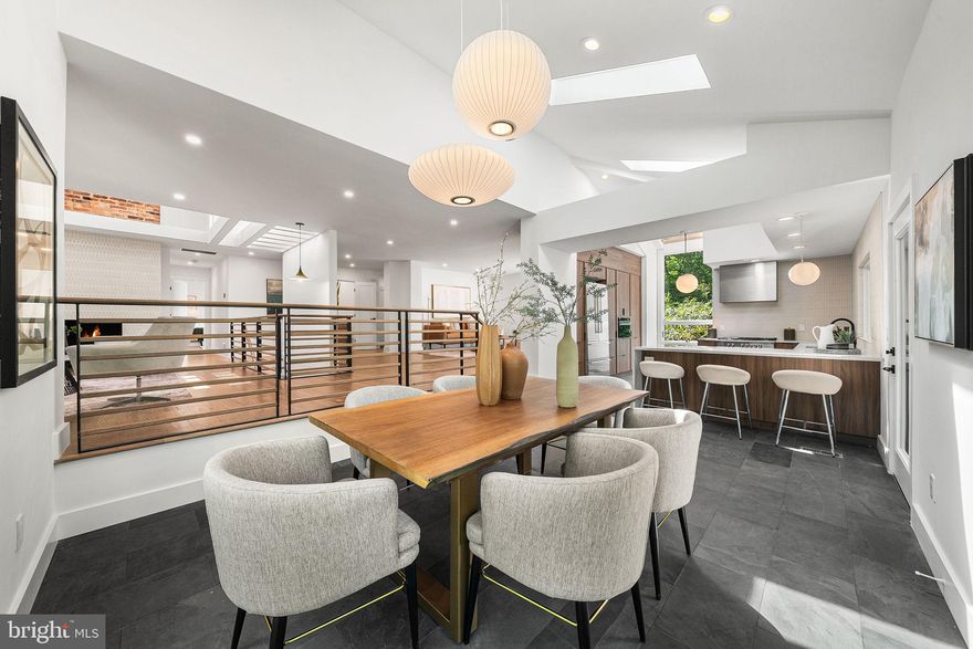 WATERFRONT - An MM Design Co Project - Fully Redeveloped Luxury Mid-Century Modern Waterfront Living with direct lake access. Welcome to 3800 Lakeview Terrace, an MCM artwork retreat in Falls Church’s coveted Lake Barcroft community. Situated on a quiet street with private lake access and breathtaking indoor and outdoor spaces, the home features 4 bedrooms, 3.5 bathrooms, 3,300 sqft of interior living space, and an additional 1,200+ sqft of deck and dock space. The home must be seen in person to appreciate all the unique architectural design details and sightlines inside and out. Nearly all the rooms on the main level have a different ceiling elevation, with natural light coming in from all different directions. MM Design Co has modernized the home while preserving its original Mid-Century Modern character.
Beyond the welcoming slate tiled foyer is a family room and living room, each with lake views, warm dark oak hardwood floors, and a wood-burning fireplace with a new MCM tile façade. The sunken kitchen and dining room feature slate flooring with vaulted ceilings, skylights, triple Herman Miller Nelson Bubble light fixtures, upper deck access, and lake views, down just one step from the living rooms and framed by new custom metal and oak MCM railings. The chef’s kitchen is ideal for culinary pursuits with walnut slab-front MCM cabinets, a Fisher & Paykel appliance suite, quartz countertops, a tiled backsplash picture window wall, custom built-in pantry cabinets, MCM pendant lights, and a chef’s sink overlooking the water.
Also on the main level is a powder room with a walnut vanity and quartz countertops, as well as a main-level primary suite and Bedroom 2 with an ensuite bathroom. The primary suite, with walk-in closet, gets natural light from two sides as well as from a skylight above, and the new primary bathroom has a massive walk-in rainfall shower with frameless glass door and a double walnut vanity with quartz countertops.
Downstairs is another family room with water views and a second wood-burning fireplace, office nook space, two more generously sized bedrooms, a third full bathroom with large walk-in shower, a large laundry room with sink, and access to the new massive lower, partially covered 1,000 sqft deck with water views and steps to the large stone patio/dock area for additional entertaining and lake access. The size of the new lower deck provides fantastic optionality in terms of usage and space.
New interior plumbing and electrical. New architectural shingle roof. New exterior doors. New expanded and resurfaced driveway and new concrete covered entrance walkway. See the Features Sheet for more details.
From the dock, there is direct access to the heart of Lake Barcroft’s 135 acres of water—ideal for boating, swimming, and fishing. Lake Barcroft is a unique enclave known for its close-knit community, five private beaches, and peaceful setting—just minutes from Washington, D.C., Arlington, Tysons, and major commuter routes.