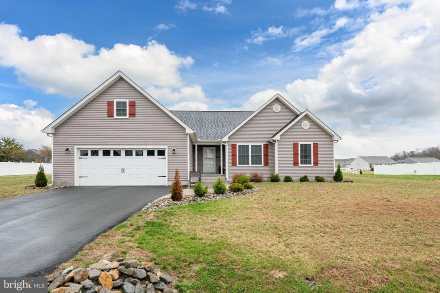 Welcome Home!
This beautiful 3 bedroom, 2 bath home offers modern living in a well-established neighborhood on the desirable east side of Seaford. Built in 2021 and exceptionally maintained, this like-new property features an inviting open floor plan with cathedral ceilings that create a bright, airy feel throughout the main living spaces.

The kitchen, dining, and living areas flow seamlessly together—perfect for everyday living and entertaining. Step outside and enjoy two outdoor spaces: a rear deck for grilling and morning coffee, plus a patio overlooking the spacious ½-acre lot. Plenty of room to garden, play, or simply relax in the privacy of your own backyard.

The home features approximately 1,667 sq. ft. of comfortable living space, along with a 2-car garage and an approved LLP septic system. All three bedrooms are generously sized, with the primary suite offering a walk-in closet and private bath.

Located close to shopping, schools, dining, and just a short drive to Route 13 and area beaches—this home blends convenience with peaceful neighborhood living. This is in Deerfield Meadows