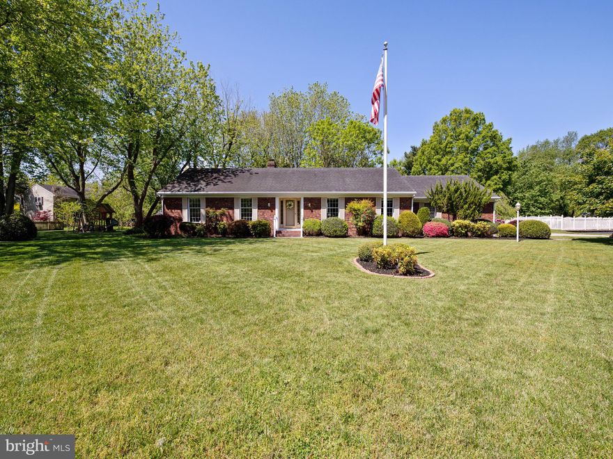 Beautiful brick front One Level Home in established neighborhood of Centennial Village.  Gorgeous lot with beautiful landscaping, 3 BR, 2 BA, master bedroom with master bath, 2 car attached garage, plus a 22 x 26 detached garage! Extra building is a great perk! Enter this lovely home to a welcoming foyer, flanked by the formal Living room and the formal dining room, each featuring chair rail and crown moldings.  The open living area will suit modern lifestyles with the kitchen and living room area combined and flexible for your style!  The centerpiece of the home is the inviting and energy efficient fireplace / pellet stove set in traditional painted brick and surrounded with quality hand crafted book cases.  This cozy gathering area features a nice addition which expanded the living space, added lots of windows and a wonderful brick floored screened-in porch.  Sliding doors from the addition access the porch and give great views of the  serene back yard!   The master bedroom features its own bathroom with tub/shower combo.  Two additional hall bedrooms provide great space for family or guests and have laminate wood flooring! The hall bath has been recently renovated for with a beautiful tile step in shower with grab bars.  A convenient  laundry room with utility sink, extra cabinets, built in ironing board is just off of the kitchen,  Large 2 car attached garage allows easy level access from driveway and includes a ramp inside to laundry room entry.  Gorgeous pergola walkway was added for shade and to connect the 22 x 26 outbuilding.  So many uses for this space, use your imagination! The building has gas heat, 1 roll up door, was set up as a pretty incredible workshop and some benches / shelves will stay.  House has several heat sources.  Main house has electric baseboard, and central AC unit 2002,  a heat pump was added in 2008 for heat/cooling when addition was put on, and the pellett stove was added.  Roof is approximately 15 years old and was a 50 year shingle, Hot water heater electric 2016, Lawn irrigation, security system , new smoke alarms installed, no history of termites.  Addition was built by renowned local builder David Lowe, known for his quality work. To make the sale easy for buyers, the sellers have had a home and septic inspection done by Bud Esham and Accurate Environmental.  Many repairs are completed on home inspection.  Minor repairs on septic were recommended and completed.  Inspections available upon request.