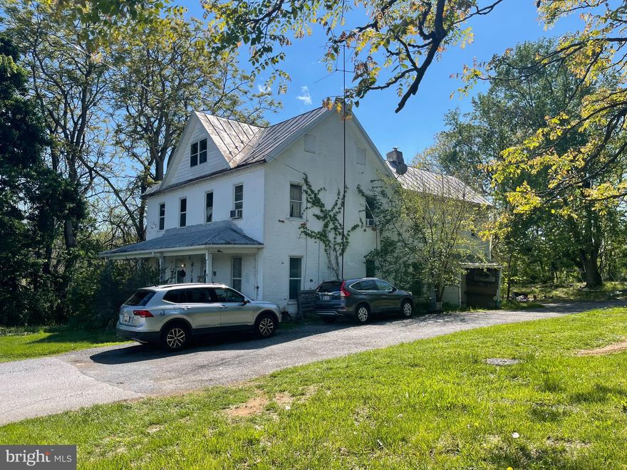 Investment opportunity located near McDaniel College. This Colonial-style property features three separate, individually metered units and offers significant potential for increased rental income through renovation. - Unit A (Front Right): 2 levels, 2 bedrooms, 1 bath; - Unit B (Front Left): 1 level, 1 bedroom, 1 bath; - Unit C (Back): 2 levels, 3 bedrooms, 2 full baths. The front unit is currently rented, providing immediate cash flow. The property previously generated over $3,100 per month when fully occupied as is. Situated on a half-acre lot that backs to state land, the building includes large rooms, covered porches, a balcony for the rear unit, and access to public water and sewer. It's proximity to the college makes this an ideal location for consistent occupancy.