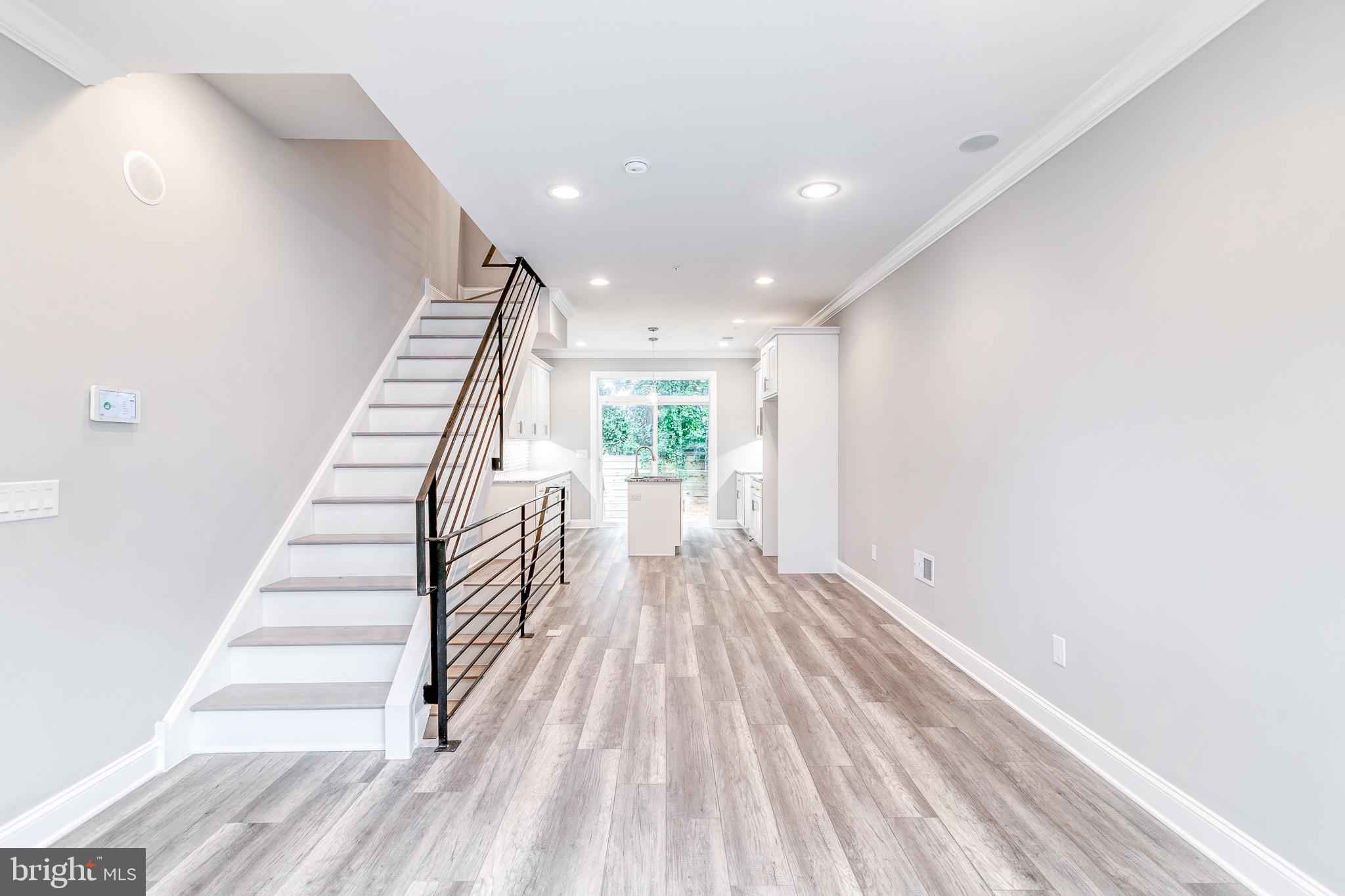 This new construction home in Norris Square Philadelphia has a 10-year tax abatement! Take a step in and discover all it has to offer. The first floor features an open living and dining space, luxury vinyl plank floors, and is drenched in natural light from the large windows. Continue into the newly designed kitchen, complete with granite counters, stainless steel appliances, a polished backsplash, and plenty of kitchen cabinets and preparation space. Open the glass door to a private rear yard, perfect for a BBQ! Come back into the house and take the stairs down to see your fully finished basement with tiled floors and a full bath. This is the perfect work from home space, additional bedroom, den, or home gym.  The second floor features two sun-filled bedrooms with large windows and a beautiful full bathroom. There is also a designated laundry closet, perfect for easy access! The third floor reveals a fantastic primary suite showcasing trey ceilings with crown molding illuminated with accent lighting. Large walk-in closet and a beautiful herringbone style tile in the bathroom. The bath also features a dual vanity and dual shower heads! Be sure to stop at the wet bar before heading up the final staircase to your private roof deck with built-in speakers and tons of built-in lighting. This home also comes with a technology package that includes a remote home security system, front door lock, thermostat control, front door camera/monitoring, and 6 months of free remote automation! You will be able to control who has access to your property and when with integrated control for door locks and arm or disarm your alarm system directly from your smartphone. Home comes with a 1-year builder home warranty from Philadelphia's Premier Home Builder, V2 Properties. A short walk to Stateside Vodka, Evil Genius Brewery, Suraya, Norris Square Park, and all of the restaurants and bars along Frankford Ave. Very accessible to public transportation and major highways. Photos are of a similar property built by the same builder.