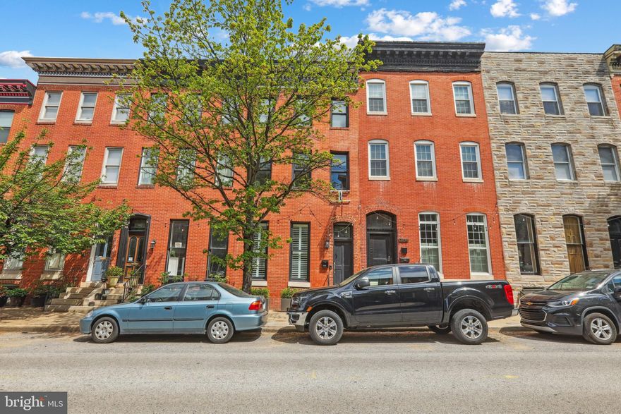 Welcome to 2104 E Pratt Street in the heart of Butchers Hill! This stunning CHAP-approved (Baltimore City Historic Rehabilitation and Restoration) property, fully renovated in 2020, offers approximately $9,000 in annual property tax savings through July 2030!! Blending historic charm with modern comforts, the home features original Heart Pine Georgia hardwood floors, a classic tin ceiling in the dining area, exposed brick, and a beautifully restored staircase. With 4 spacious bedrooms and 4.5 bathrooms, including a finished basement, the layout is ideal for both everyday living and entertaining. Enjoy two brand new decks with spectacular city views, plus an oversized one-car garage with an additional parking space. Located just a few blocks from Patterson Park and Johns Hopkins Hospital, and within walking distance to top-rated restaurants such as Marta, La Barrita, and Charmed Kitchen, you're also just minutes from the vibrant scenes of Fells Point and Harbor East. Don’t miss this incredible opportunity to own a truly special home in one of Baltimore’s most sought-after neighborhoods!
