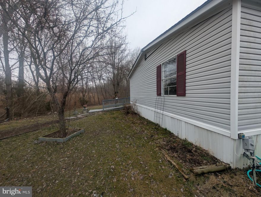 Beautifully remodeled 3 bed/2 bath in Bush River Manor. Home sits in a private wooded setting. Ideal for sitting outside with your drink of choice.  Lot rent is $961