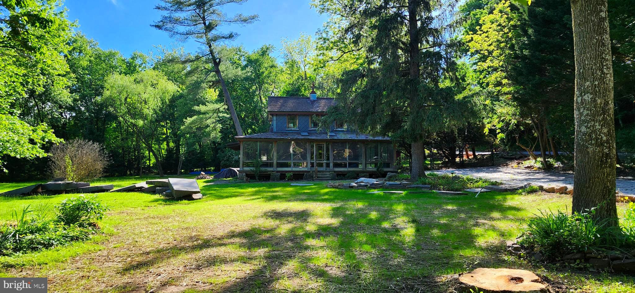 Discover timeless charm and beauty at this one-of-a-kind home along the water’s edge on French Creek. Season after season you will appreciate the beauty and tranquility of this beautiful location – daffodils and ferns along the creek in spring, fall colors in autumn, and a snow lined embankment in winter. Fishing, kayaking, and canoeing can all be a few steps away from your door. The stone driveway was a labor of love years in the making. Stone masons worked to incorporate stone and marble in the design. One of many special features encompassed on this extraordinary property. Vintage working city lamp posts were placed along the creek side. The owner brought numerous elements from old Philadelphia and New York to enhance his vision. The property has many interesting design features such as arbors, large stone slabs from the local quarry, and stone walkways. There are plans displayed at the property which reflect his vision for expansion. The rustic home built in 1900 has potential to be a magnificent show place. The owner- a glass artist- installed custom artisan glass windows. The enclosed wrap around porch offers views on three sides to a breathtaking landscape. The owner reconfigured the second level to be an open master bedroom. Grand piano legs support the bar in the great room. The magnificent oversized double hinged doors –were brought from Philadelphia. The wainscoting and much of the paneling (made from church pews) were brought from a church in Philly. From New York a large cooler door with multi panel design with a frosted glass window was added leading to the mechanical area. There are art deco lights, vintage lights, vintage stained and leaded glass, doors, molding, and many other architectural and decorative elements. There are treasures in every area of the house and the surrounding property with the artist vision apparent throughout. Come and visit this unique home and experience the past, present, and the future that you envision for this remarkable place.
Estate has been made aware that property is on the East Pikeland Township historic registry.