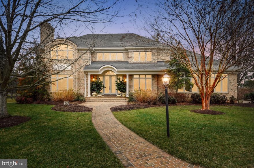 Enjoy resort-style living in a gated waterfront community with the added bonus of a deeded 30-ft boat slip at the private marina. This extraordinary 7,000 sq ft home artfully combines classic all-brick architecture and elaborate interior millwork with high-level modern amenities and design features with emphasis on entertaining and the added convenience of an elevator.  The 2-story Foyer highlights a dramatic sweeping staircase and introduces handsome quarter-sawn oak flooring. The Chefs Kitchen is masterfully designed with honed black granite counter tops contrasting with creamy maple cabinetry which conceals a multitude of amenities and appliances for a streamlined effect. An impressive waterside Owners Suite showcases an extravagant Luxury Bath. (3) prominent gas fireplaces are featured, while abundant windows and tall atrium doors capture South River water views. Exterior notables include the Alaskan yellow cedar waterside deck and the cedar-simulated roof. The community association provides your lawn mowing, mulching, trimming and snow removal while also maintaining the marina, pool, tennis, playground, nature path and 24/7/365 staffed gated security.