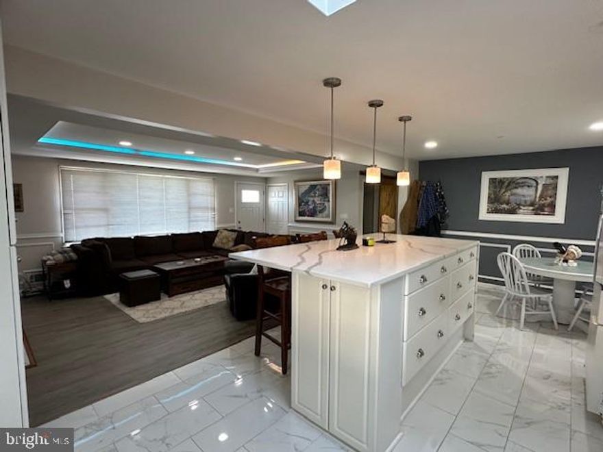 This beautiful high-end renovated home  located in the desirable community of Severna Gardens in the heart of Severna Park features 4 bedrooms and 3 full custom ceramic tile bathrooms.  Walking distance to Severna Park High School.  Custom features through-out highlighted by your stunning gourmet, open kitchen.  Waterfall-style, quartz 4 person kitchen island with tons of cabinets space.  Large, Master bedroom with ensuite bath.  Big, living room with fireplace and recessed lighting and custom windows that provide lots of natural light.  Walk-through your sliding Wood barn doors into your fully finished basement.  This space is HUGE with a custom-built bar that is perfect for entertaining friends and family.  4th. bedroom in basement with full bath.  Plenty of storage space in your laundry room with full size washer and dryer.  Relax  in your breezeway porch or back yard patio and enjoy your coffee and paper in the morning and cocktails in the evening.  Comes partially furnished, if needed.  This home has it all!