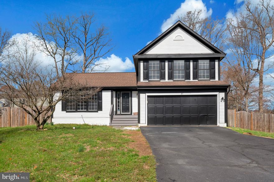 Rare opportunity to own a spacious four-level home in the heart of town, ideally located in a highly sought-after school district and just minutes from major commuter routes with convenient access from two highway exits. Enjoy close proximity to Stafford Marketplace as well as the newer Embrey Mill shopping area featuring Publix, all within a charming sidewalk community with low HOA dues.

Nestled off the main road, this home offers a long private driveway and excellent curb appeal with a freshly painted exterior, complemented by stylish black gutters and accents. Step inside to find a traditional yet open main level featuring a formal living room, dining room, and a bright kitchen with vaulted ceilings. The kitchen is beautifully appointed with white cabinetry, quartz countertops, a center island, stainless steel appliances, upgraded lighting, and a modern backsplash. There is also ample table space and sliding glass doors leading to a spacious deck—perfect for entertaining. The dining room showcases luxury vinyl plank flooring and a large bay window that fills the space with natural light.

Upstairs, you’ll find all bedrooms, including two generously sized secondary bedrooms with ceiling fans and a shared full bath. The expansive primary suite features cathedral ceilings, LVP flooring, a ceiling fan, a walk-in closet, and a private en suite bath with dual vanities, upgraded tile, and a large tub/shower combination.

The first lower level offers a welcoming family room with high ceilings, a cozy corner gas fireplace, and a second set of sliding glass doors leading to the backyard deck. This level also includes a conveniently tucked-away powder room, a separate laundry room with washer, dryer, and a window for natural light, and access to the two-car garage.

The second lower level provides incredible flexibility and can serve as an additional family room, in-law suite, or teen retreat. It features a luxury full bath with a double sink vanity, upgraded mirrors and lighting, and an oversized walk-in shower with designer tile.

Outdoor living is a standout feature, with multi-level decking overlooking a nearly half-acre, fully fenced backyard—ideal for entertaining, pets, and play. Additional highlights include a new HVAC system for peace of mind.

This home truly offers space, style, and an unbeatable location—don’t miss it!