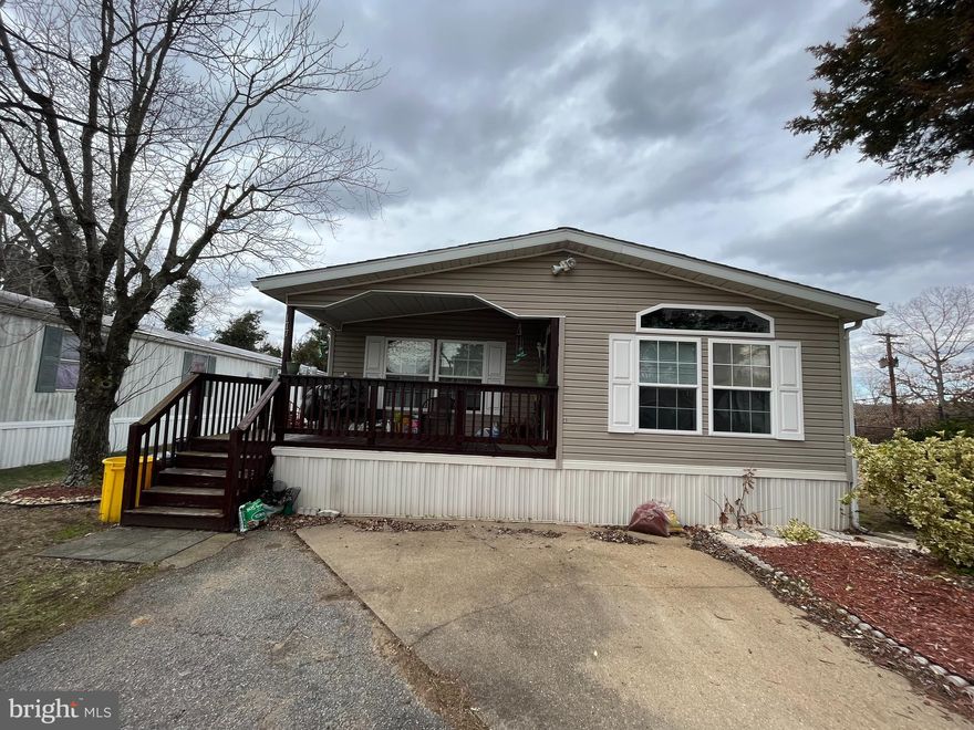 You will fall in love with this charming, spacious, beautifully maintained double wide home.  Spend Your Mornings  and Evenings Relaxing on Your large front Porch. Walk into an open floor plan with cathedral ceilings,  updated cabinets and luxury vinyl flooring throughout. You also get a separate utility room with  
washer & dryer. All three bedrooms are generous in size; master suite includes full bath, soaking tub and 
walk-in closet. Many upgrades completed within the last two years to include New roof, new stove, refrigerator,  washer and dryer. Community offers boat ramp, swimming pool, playground, 
dog park, basketball courts and more! Close to Schools, Shopping and Restaurants. Lot rent is $817.00 per month and subject to increase every year.  Park approval is required and application is in the document section.