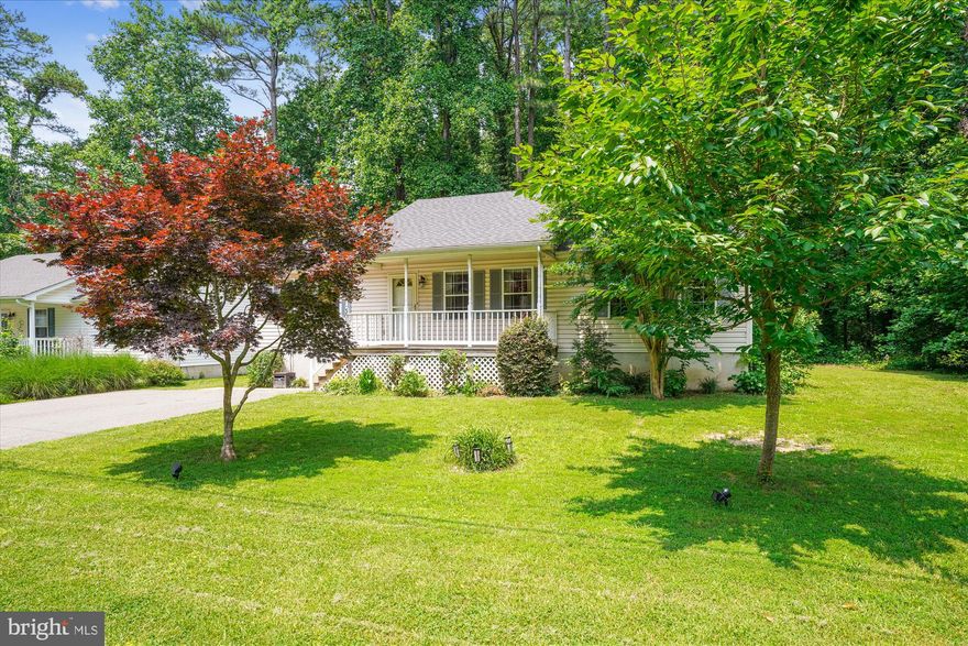 Renovated kitchen with granite countertops, and plenty of cabinetry opens to your great room with pitched ceiling and gleaming hardwood floors. Spacious Primary suite includes a full bathroom and walk-in closet. Generously sized guest rooms and hall bath. The lower level is fully finished with a large entertaining area, a beautifully renovated full bath and two sectioned off rooms that could be a den, Home office, or used as two additional bedrooms (just missing the window) so the possibilities are limitless! The backyard provides privacy allowing you to take in those nature views. Low HOA fees of $180 per year yet  walking distance to water access for boating, jet skis, kayaking etc. Within minutes, you’re sailing along the Chesapeake Bay! Enjoy the community beach & fishing pier..just in time for summer!