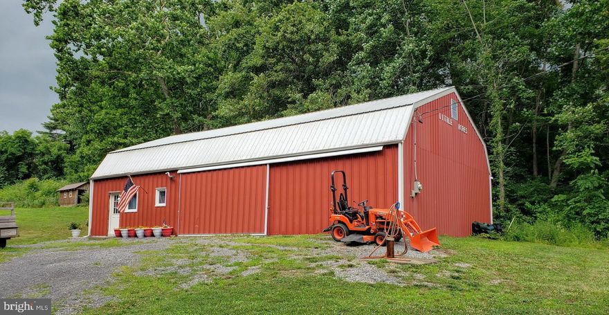 Private yet close to amenities! 56X32 Garage/Barn on 2.27 hidden acres with an awesome 1004 sf apartment built in. Spacious open concept kitchen, dining area, living rm, full bath with tub/shower combo, and dedicated laundry rm round out the first floor. The loft area includes a lg  bedroom, half bath, and spacious closet. 12X16 barn for your critters or additional storage. Mini splits provide heat and AC. There is also a chimney for a wood stove or other heat source.  Drilled well and on site septic w/  a sand mound. 200 Amp electric service. Bring your critters and make it home or use as your own private get a way with plenty of storage for all your toys. Part of property is in flood zone due to sm creek. Private Rd - no drive-bys please.