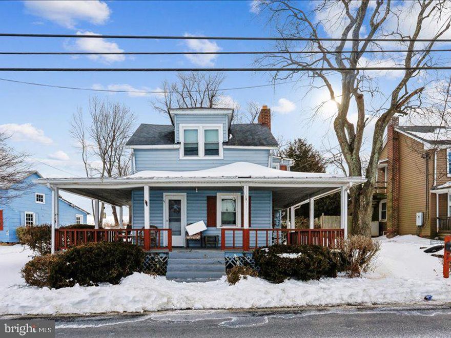 Ready for a country home?  Bordered on 2 sides by farmland. Sunset views from wrap around porch. Approximately 8 years ago property (house) received new shingle roof, double pane windows, vinyl siding, & well pump replaced.  This vintage property has large rooms, all bedrooms accessed from a hallway, (no walk thru bedrooms), a large 2 car garage with a large storage loft.  Needs your tender touch to update interior.
