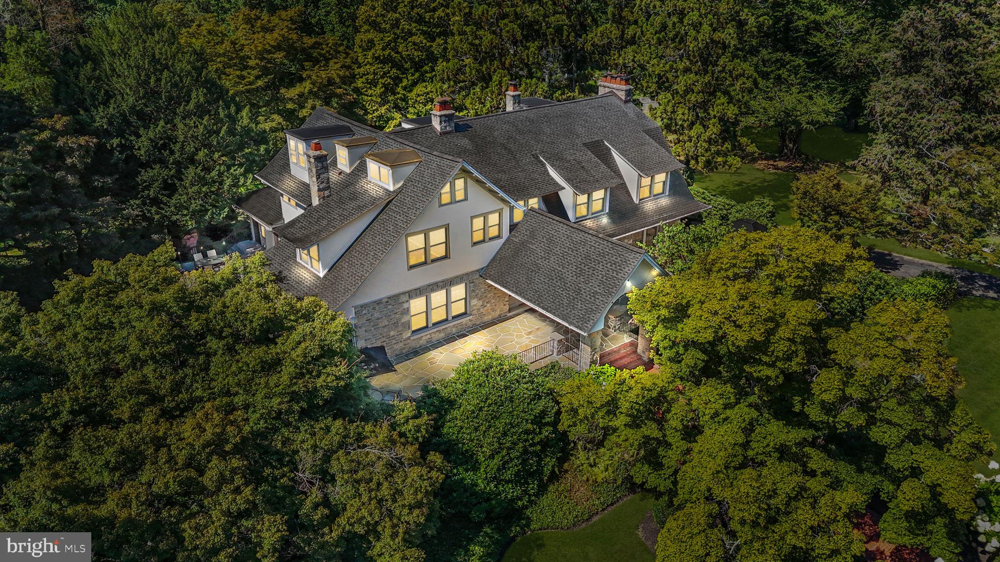 This extraordinary estate is unlike anything else on the market in Bucks County. The original residence of historic Delavue Manor, this property exudes a level of magnetism and charm rarely encountered. Situated on nearly 3 acres of beautifully landscaped grounds, the home offers nearly 8,000 square feet of exquisitely finished living space, with soaring ceilings, grand architectural details, and timeless character. With 5 bedrooms, 5 full bathrooms, and 2 half bathrooms, this residence combines the prestige of history with the comforts of modern luxury. >>>>> The location is nothing short of exceptional. Nestled in the heart of Yardley, the property enjoys close proximity to Yardley Borough—known for its boutique shops, acclaimed restaurants, and riverside trails along the Delaware Canal. The estate is also ideally positioned for commuting professionals, with effortless access to trains to both New York City and Philadelphia, as well as quick connections to I-95 and Route 1. For the discerning buyer seeking convenience, lifestyle, and prestige, this property is unmatched. >>>>> Upon arrival, the gated circular driveway sets a commanding tone, leading you to the dramatic grand entry. From the moment you step inside, the sense of scale and craftsmanship is undeniable. Original inlaid hardwood flooring, restored millwork, and striking stone and Mercer tile fireplaces reflect the rich history of the home, while carefully integrated renovations bring modern comfort and functionality. The grandeur continues outdoors, where a completely redone wraparound flagstone patio and multiple entertainment areas create an unparalleled backdrop for gatherings. >>>>> The kitchen is a true showpiece, completely renovated in 2020 with custom-designed finishes that cater to both style and function. Double Sub-Zero refrigerators, a two-cycle built-in wine cooler, Wolf appliances, a massive quartzite center island with seating for six, and vaulted ceilings make this kitchen the heart of the home. A butler’s pantry expands the space with a coffee bar, instant hot water, reverse osmosis drinking water, and extensive storage. Every detail was thoughtfully curated to elevate the culinary and entertaining experience. >>>>> Beyond the kitchen, the estate unfolds with spaces designed for both relaxation and productivity. A dedicated first-floor office and a separate library provide refined environments for work or study. The library leads seamlessly to an outdoor fireplace, creating a year-round retreat. Additional highlights include a dramatic pergola-shaded dining space surrounded by mature growth for privacy, and a finished lower level with nearly 1,000 square feet of living area—complete with a hidden staircase leading to a speakeasy, a one-of-a-kind feature that embodies the home’s unique character. >>>>> Further enhancing the property’s appeal is the oversized detached three-car garage, constructed from the same stone quarry used in the original home design. One bay has been transformed into a climate-controlled golf simulator room, creating an entertainment space that rivals the best private clubs. This seamless blend of historic authenticity and modern amenities is what makes the estate truly singular. >>>>> Every aspect of this property has been meticulously curated to create a home that is both a private sanctuary and an entertainer’s dream. With its storied past, irreplaceable architectural details, and world-class updates, this estate is more than just a residence—it is a landmark. For high-net-worth buyers seeking a showpiece property with unparalleled access, privacy, and prestige, this is a once-in-a-lifetime opportunity in the heart of Yardley