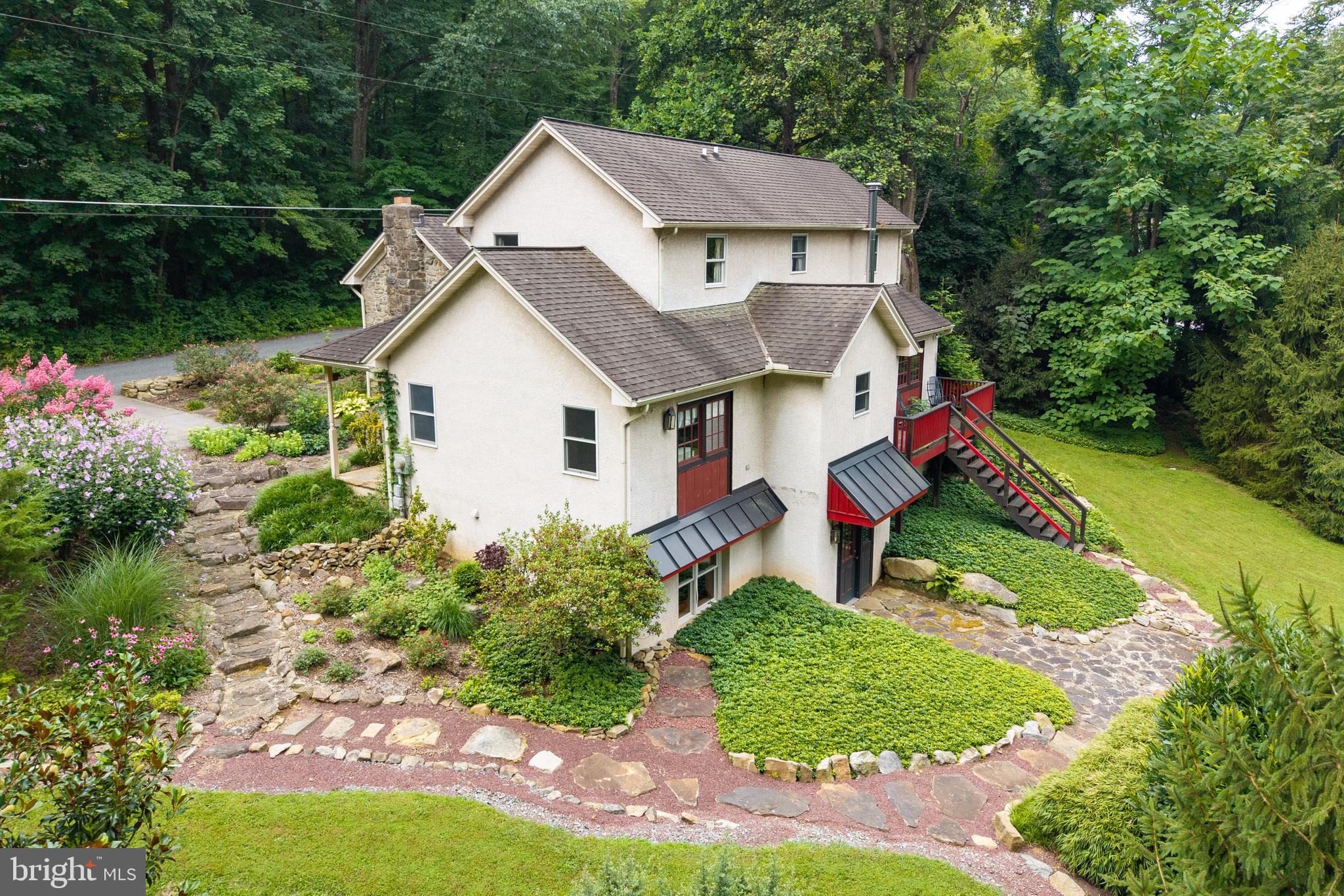 Nestled on a quiet road in picturesque Warwick Township, this impeccably maintained Pennsylvania farmhouse-style home offers a seamless blend of history, charm, and modern comfort. Set against a backdrop of manicured gardens and a tranquil backyard, the property invites you to experience the serenity and privacy of true country living. Originally built in 1835, the front section of the home showcases authentic period details including exposed beams, original wood flooring, and a stone fireplace. The main level features a living room, a formal dining area, and a kitchen accented with a stone wall, antique cupboard, soapstone countertops and sink, and period lighting. Also on the main floor are the primary bedroom, full bath, and a convenient laundry room. Upstairs, you’ll find 3 additional bedrooms, an office/sitting/playroom area, and a full bath - perfect for family, guests, or flexible work-from-home space. Throughout the home, pristine oak, pine, and brick flooring add warmth and character. The fully finished lower level offers separate living quarters with its own private entrance. Complete with a kitchenette, sitting area, bedroom, full bath, and storage, this space is ideal for in-laws or guests. Details like brick flooring and a corrugated tin ceiling add a rustic charm. Located in the Owen J. Roberts School District, this home is just minutes from the PA Turnpike and a short drive to Morgantown, Exton, and nearby shopping and restaurants. Outdoor enthusiasts will love living in Warwick Township - Chester County’s #1 township for preserved land - with endless nearby opportunities for biking, hiking, kayaking, paddleboarding, boating, fishing, and so much more. Warwick County Park is a stones throw away. Start living the Warwick Township lifestyle today!