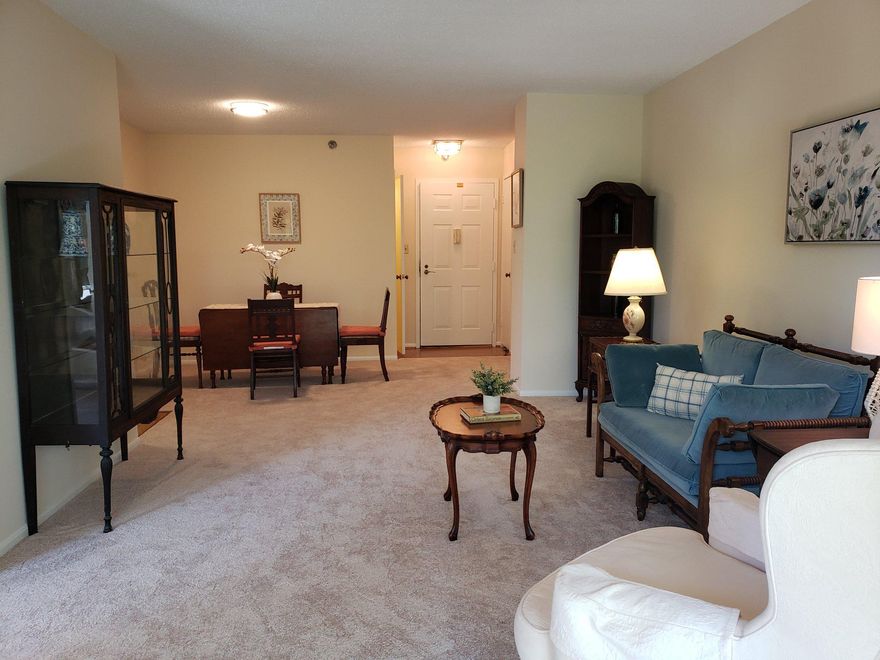 Welcome to maintenance-free living in one of Montgomery County's most sought-after age 55+ Active Adult Communities.  This bright, spacious 5th-floor Condo - conveniently located near the building elevator - offers 2 bedrooms, 2 baths with a thoughtfully designed layout.  The Primary Suite features an ensuite bath, a walk-in closet and a secondary closet.  On the opposite side of the expansive Living Room, the second Bedroom also serves as a private suite with a full bath and Built-in Shelving, making it also perfect for use as a Guest Suite, Den or Office. The home features a bright, tablespace Kitchen with a granite countertop, stainless appliances and lovely LVP Flooring.  An open Dining area flows seamlessly into the large and inviting Living room.  Step through sliding glass doors to enjoy you enclosed Balcony, which offers peaceful, scenic views of the surrounding trees and greenery.  Recent upgrades include a "NEWLY INSTALLED" HVAC system (April 2026)", fresh paint throughout and brand-new wall-to-wall carpeting. The unit also includes an in-unit washer and a dryer, generous storage space with an oversized closet and two additional coat closets in the foyer and dining areas.  Professionally cleaned and move-in ready - Schedule your tour today!!  Community Amenities include: Two (2) Clubhouses, MedStar Medical Center, two (2) restaurants and a bar, 18-Hole Golf Course, Indoor and Outdoor Swimming Pools, Garden Center, Media Center, Tennis/Pickleball Courts, Art Center, Ceramics Studio, Travel Service, Woodworking Shop, Free community bus service plus a plethora of Clubs and activities.