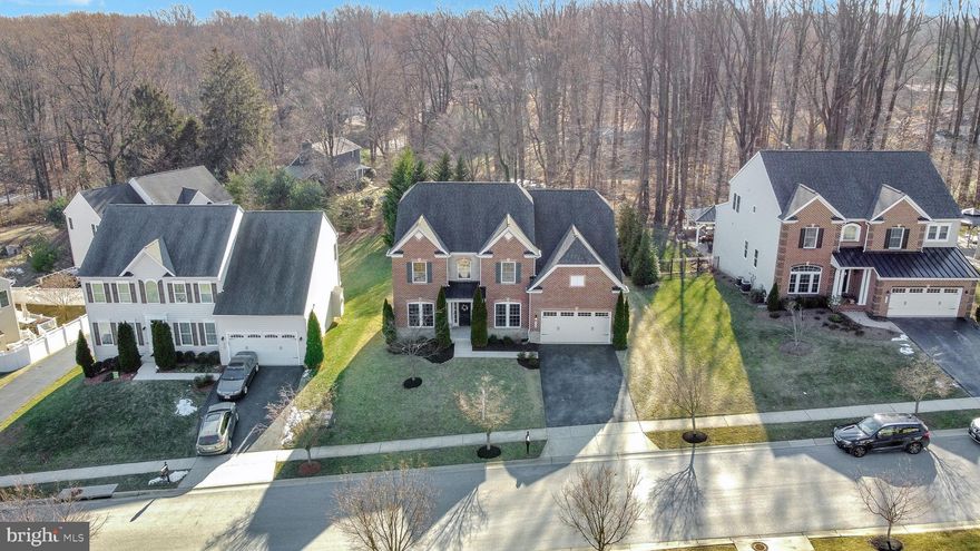 Absolutely stunning NV homes (Empress model) located in Bonnie Branch Woods community. This well maintained home features 5 bedrooms, 3 full baths, and 1 half bath including tons of upgrades and ample sunlight throughout the house. Main level - First floor features an office room, 2- story foyer, and a living room, crown molding, hardwood floor, upgraded kitchen with SS appliances, granite countertops, center-island with pendant lighting, formal dining with wainscotting, pantry, sunroom, family room with fireplace, 9 ft+ ceilings, oak stairs. The private home boasts French doors, ceiling fans, and recessed lighting. Second floor includes four generous bedrooms with multiple walk-in closets. Owners suite with remarkable tray ceiling and his/her walk-in closets. The luxurious owner's bath features double vanities, soaking tub, oversized standing shower. Hallway bathroom, laundry room. The finished basement includes a full wet bar, full bath with standing shower, bedroom, media room with 7.2.4 home theater prewiring and walkout double door. Brand new stone patio and a fire pit backing to woods for a nice family gatherings. 2 car garage with an extended driveway for additional driveway parking. Additional upgrades included new carpet, fresh coat of paint and 2020 finished basement. This house has tons of additional upgrades and must-see home.