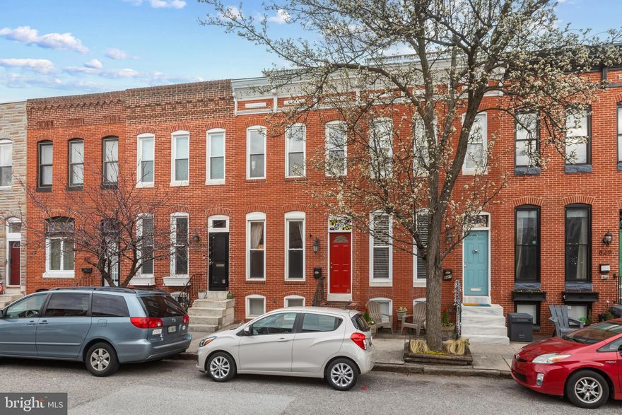 Beautiful 2 bedroom , 2.5 bath Canton rowhome with parking pad and roof deck.  Open concept and modern style enhanced by hardwood floors, recessed lighting, exposed brick, and built-in shelving.  Gourmet kitchen boasts granite counters, updated stainless steel appliances including gas range, built-in shelving,  and island seating.  Large light-filled primary bedroom with attached bath with dual vanity and walk-in shower.  Upper level is completed with an additional bedroom, full hall bathroom with jetted tub and walk-in shower, and access to double tier composite rear and roof deck.  Partially finished lower level and laundry/storage area.  Updates include kitchen appliances (June 2023), hot water heater (August 2024), and freshly painted.  Great location on tree lined street - just two blocks from Canton square, walking distance to Patterson Park, shopping and restaurants!  City living at it's finest - location, parking, and the beautiful views from your very own roof deck!