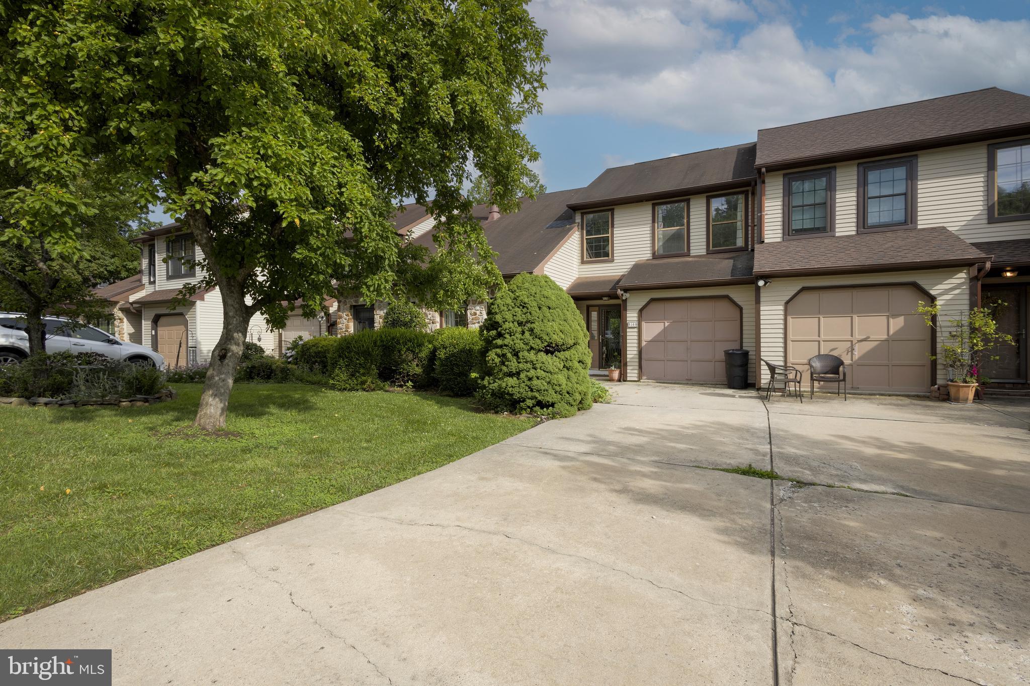 The Stotesbury Townhouse community in Wyndmoor was built in the 1980s on the grounds of the Edward Stotesbury estate. Remnants of its gilded age grandeur such as marble columns, belvedere steps, and monumental statuary dot the rolling landscape, giving this contemporary community a sense of the past. The modest HOA fee keeps the tree-lined streets, the sidewalks, and the open green space manicured for all the residents. This community has buried utility lines, meaning that electricity will likely stay on even when the inevitable bad weather hits.
The front entrance faces the driveway and opens into the large foyer with easy-care tile flooring. To the left is a living room with vaulted ceiling and large front windows. Toward the back of the house is a bright dining room and a spacious, fully-equipped kitchen. A large peninsula adds valuable work space and room for casual dining at the counter. There are large sliding doors to a spacious deck overlooking open green space, giving a treehouse-like feeling.
Up the stairs is a large balcony overlooking the living room that lends an airiness and volume to the house that belies its 1500+/- square feet indoor space. (Interestingly, many homeowners in the community have created a third bedroom out of that unbuilt space on the second floor.) The primary bedroom has a beautiful en-suite bath and plenty of closets. A second hall bath serves the second bedroom, located at the front of the house. The laundry closet is conveniently located on the second floor with an energy-efficient washer and dryer in good condition.
The big surprise of the house is the large, finished basement with wood burning fireplace, and a large sliding door that leads to a stone patio. This bonus space is perfect for family gatherings, late night streaming, or raucous games. The basement living space opens into a spacious backyard full of greenery, featuring occasional visits by rabbits, deer, squirrels, and foxes.
Off the finished space is unfinished basement area that is suitable for storage. The house has an attached one-car garage, great for additional storage or for an actual car! Located in desirable Springfield Township, Stotesbury is close to highways, regional rail, shopping, Chestnut Hill, and all the benefits of the near suburbs of Philadelphia. This is one that won't last