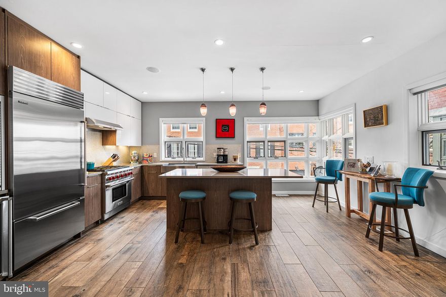 Set on one of Queen Village’s most picturesque blocks, 114 Bainbridge Street is a truly spectacular 25-foot-wide residence that offers a rare combination of scale, light, and thoughtful design. The expansive footprint creates graciously proportioned spaces, effortless furniture placement, and exceptional natural light throughout—an uncommon luxury in city living.

This 4-bedroom, 3 full and 1 half bath home blends everyday comfort with elevated entertaining. At the heart of the home is a stunning chef’s kitchen designed for serious cooking and memorable gatherings. Outfitted with premium Wolf and Sub-Zero appliances, abundant prep space, endless storage, and generous room for dining and entertaining, the kitchen is flooded with natural light and seamlessly supports both intimate dinners and large celebrations.

The home’s versatility is equally impressive. Multiple flex spaces provide endless options—ideal for working from home, play spaces, fitness area, or secondary living spaces. The finished lower level can easily function as an in-law or guest suite and walks out to a beautiful bi-level garden terrace, creating a seamless indoor-outdoor lifestyle rarely found in the neighborhood. A climate controlled wine cellar adds an additional touch of refinement for the discerning host.

Practical luxury continues with the highly coveted two-car garage—an extraordinary amenity in this location.

Located in the desirable Meredith School Catchment and in easy access of I-95 and the Ben Franklin Bridge, this location offers unrivaled convenience and walkability while being surrounded by Queen Village’s distinctive historic architecture and charm.  Walk just moments to Headhouse Square, Society Hill, and the neighborhood cafés, boutiques, and restaurants along 4th Street. 

114 Bainbridge Street is a rare opportunity to own a wide, light-filled, impeccably appointed home in one of Philadelphia’s most vibrant and architecturally rich neighborhoods.