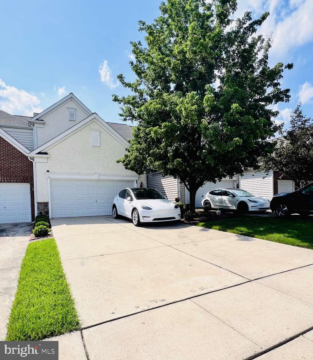 Welcome to your dream home in the highly coveted Longford Crossing community—a perfect blend of elegance, comfort, and unbeatable convenience. This beautiful carriage home offers 3 spacious bedrooms, 3.5 baths, 3700 sq ft of total living area ( 2726 above ground + 974 basement) and 6 total parking spaces, including a 2-car EV-ready garage. Inside, the main floor stuns with rich hardwood flooring throughout and a seamless flow into sunlit living areas, illuminated by recessed lights installed in 2020 and controlled by Wi-Fi-enabled switches. It offers a spacious, open floor plan. Magnificent, oversized kitchen with large center island (including a sink and stool seating area), corian countertops, pantry, and a sun-filled breakfast/informal dining room. Open living/dining area features crown moldings and wainscoting. Office/Den features French doors, and a family room with a gas fireplace. Step outside onto the maintenance-free deck (2019) with built-in lighting and enjoy peaceful views of the private flat backyard and the wooded trail directly behind the home. The luxurious master suite features a generous sitting area—ideal for lounging or working from home—while large windows flood the space with natural light and frame scenic views of the woods. Downstairs, the finished basement (2020) offers incredible versatility with a full bath, ample flex space, and plenty of storage in the unfinished area. You’ll also enjoy peace of mind with a new roof (2022), water heater (2019), and refrigerator (2024). This home is just a short 3-minute walk to the community tots park, and it's ideally located near the end of a quiet cul-de-sac. With ample parking throughout the neighborhood, low HOA fees, and Wi-Fi-controlled permanent exterior lighting, every detail is designed for easy living. And when it comes to location, it doesn’t get better—mere minutes from 422, Wegmans, Providence Town Center, Target, BJs, King of Prussia, Black Rock Park, and top employers like SEI, Pfizer, and GSK. Don’t just settle for a house—step into a lifestyle you’ll love. Ready to take a look?