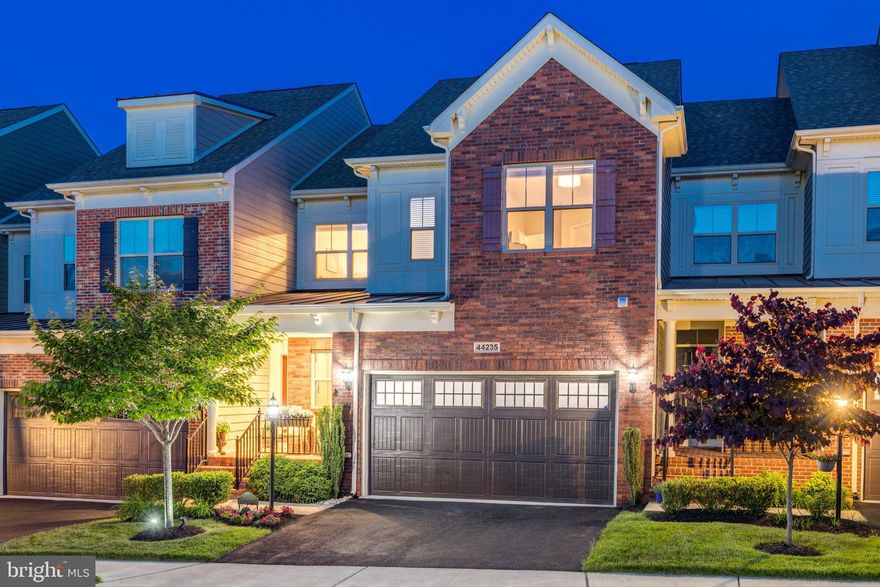 Open House Sunday June 18th 2-4pm**Better than Brand New*Completely move-in ready, In impeccable condition!  Sophisticated, yet warm. Luxurious, yet inviting. That is how this magnificent original-owner Parsons townhome, featuring over $75,000 worth of superior upgrades, can best be described. Boasting nearly 4,000 square feet of interior living space across three finished levels, including a walk-out basement with full height ceilings and double windows, this impressive residence offers a refined indoor-outdoor living experience that is rarely seen. A custom-designed, 320-square-foot Trex deck is located just off the main level great room, complete with a pergola, privacy fencing, and automatic LED lights in the deck floor and stairs. Venture from the deck down to a landing surrounded by professional landscaping, lovely trees and shrubs, perennial gardens and new sod, all secluded by a full fence that was sealed in 2019 and painted on both sides in 2022. At the bottom of the stairs, a 275-square-foot paver patio awaits, partially covered to allow you to enjoy outdoor living in nearly any weather. The home is also equipped with an under-deck draining system, extended downspouts which exit through the 37-foot pressure-treated timber wall, and inclusion of river rock strengthen property drainage, providing a buffer from the elements, and a curved, 15-foot paver wall acts as both a seating area and garden retaining wall. Privacy from neighboring homes is also enhanced by a row of Arborvitae along the white fence. These extensive, thoughtful exterior features are complemented by an interior flow that is both timeless and inviting. Welcome inside the covered entry to an inviting foyer, creating natural separation from the entry, living areas and a powder room nearby. Gleaming hardwood floors adorn the living spaces on the main level, where you will find the upgraded kitchen, great room, formal dining area, expansive primary suite, separate enclosed laundry room, and access to the two-car garage recently finished with epoxy flooring. The upgraded chef’s kitchen showcases granite countertops, stainless steel appliances, rich wood cabinets, and a large center island perfect for cooking prep, casual meals, homework and entertaining. The great room’s soaring, vaulted ceiling creates an airy ambience along with ample natural light from large windows. Retreat to your main-level primary suite, a true oasis complete with tray ceiling, large walk-in closet, dual sink vanity and separate shower. Upstairs, you’ll find a large loft overlooking the great room, two secondary bedrooms, a spacious full bath, and a bonus living area that could double as your game room, media room or work-from-home office. Finally, the finished lower level is expansive and bright, with an additional full bathroom and multiple large closets for extra storage. All located in the popular 55+ community of the Vistas at Lansdowne! You’ll love the top-notch community amenities including a pool, clubhouse, lounge, fitness center, tennis courts, art studio, community shuttle, and abundant green spaces. And with its prime location close to historic downtown Leesburg, One Loudoun retail and restaurants, and Dulles Airport, this home provides both modern convenience and a low-maintenance, active lifestyle.  Welcome Home!
