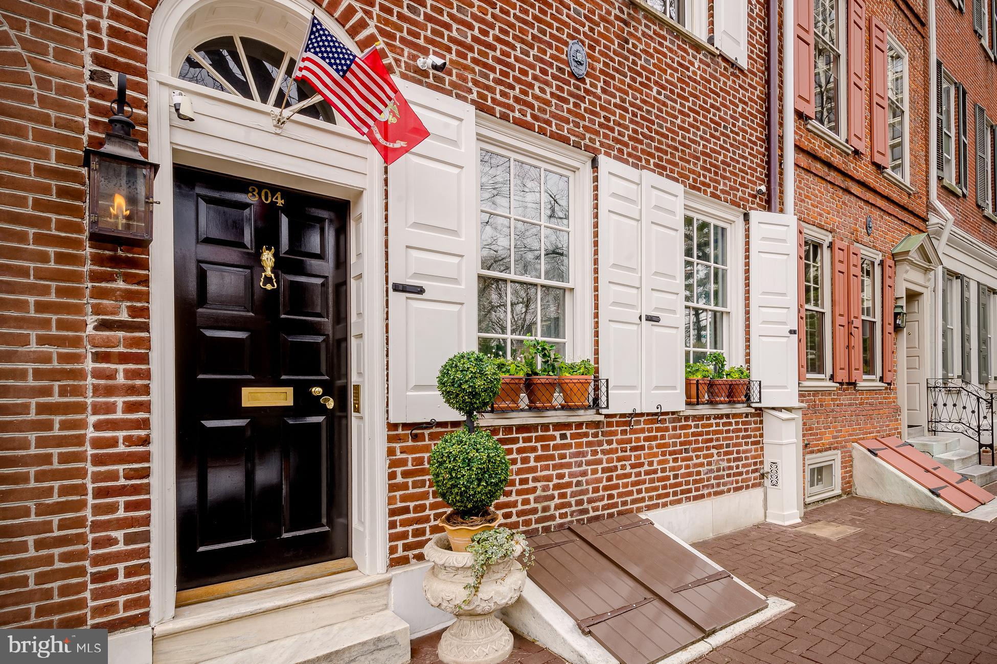 This historically registered 4 bedroom, 4.5 bath, built circa 1780 is located in arguably the most beautiful neighborhood in Philadelphia. Society Hill, one of our nation's oldest and most historic neighborhoods offers beautiful colonial lined streets and a weekly covered farmer's market in historic Headhouse Square a block from your front steps. Located on a picturesque cobblestone street with brick lined sidewalks, this luxurious home blends modern amenities with restored original details throughout. Masterful complete home renovation completed in 2017. The formal living room is fully paneled in French proportioned millwork, fireplace is brick-lined in a herringbone pattern with authentic Dutch Delft tile and mantle modeled after a French 18th century marble fireplace. This home is simply exquisite! Full gourmet top-of-the line chefs kitchen that fulfills every cooks dream offering a full-size wine refrigerator, hidden paneled appliances, 2 freezer drawers, large gorgeous pantry with a pocket door featuring a decorative brass grill from England. This designer kitchen offers a La Cornuefe 110 stove in Paris Blue. Beautiful custom designer lantern lighting sits above the island coordinating the soft French blue colors throughout this spectacular space. An open dining space plan includes a hipped skylight and 3 sets of custom mahogany French doors creating an orangerie leading out to the generous sized city courtyard. The breathtaking outdoor space has a subtle checkerboard stone courtyard with boxwood planting beds lined in Belgium block. An elegant cedar trellis completes this very private outdoor oasis with hidden surround sound. Stunning en-suite Master bedroom with lofted space has the second of 3 full working fireplaces surrounded in gorgeous quatrefoil mosaic tile. No expense was spared in the renovation of this amazing home! Spa like master bath with steam shower, waterworks fixtures, stand alone deep soaking tub, custom mirrored French closet doors; all surrounded in Carrara marble in a Romanesque style mosaic. His and hers vanities with fully appointed private Toto toilets. The other two designed en-suite bedrooms have generous full baths. The family room is spectacular in a Ralph Lauren style, English library feel with a wood burning fireplace featuring original Valley Forge blue stone surround. A lofted space, that is sure to be a favorite, offers a wet bar, entertainment area, and office space. The double bi-level decks are accessed via French doors off of the bar space. With Ipe wood tiles, natural gas grill and fire table hook-ups, the top deck offers generous entertainment space with a spectacular 360 view of the gorgeous Philadelphia waterfront, skyline, and front row seats across from fireworks shows throughout the season. This elegant home has too many amenities to mention. Smart home with Elan automation, a robust security system including 5 cameras with night vision, Lutron intelligent light switches, top-of-the-line fully integrated A/V! Finished basement as well as an elevator accessing the top to the bottom of the house, AND seven years left of ten year tax abatement! This home is exceptional! ** Seller will pay for parking for 1 year from purchase, in nearby secured lot or garage**