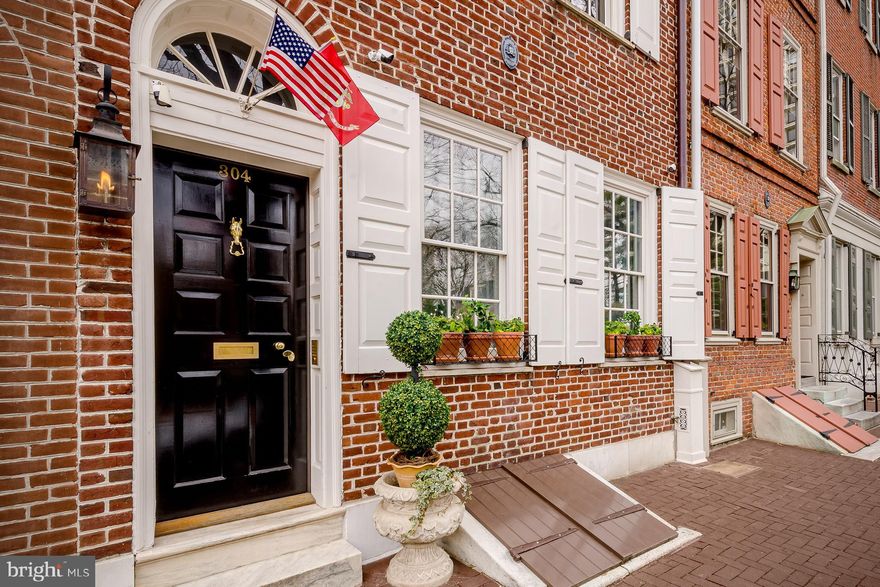 This historically registered 4 bedroom, 4.5  bath,  built circa 1780 is located in arguably the most beautiful neighborhood in Philadelphia. Society Hill, one of our nation's oldest and most historic neighborhoods offers beautiful colonial lined streets and a weekly covered farmer's market in historic Headhouse Square a block from your front steps. Located on a picturesque cobblestone street with brick lined sidewalks, this luxurious home blends modern amenities with restored original details throughout. Masterful complete home renovation completed in 2017. The formal living room is fully paneled in French proportioned millwork, fireplace is brick-lined in a herringbone pattern with authentic Dutch Delft tile and mantle modeled after a French 18th century marble fireplace. This home is simply exquisite!  Full gourmet top-of-the line chefs kitchen that fulfills every cooks dream offering a full-size wine refrigerator, hidden paneled appliances, 2 freezer drawers, large gorgeous  pantry with a pocket door featuring a decorative brass grill from England. This designer kitchen offers a La Cornuefe 110 stove in Paris Blue. Beautiful custom designer lantern lighting sits above the island coordinating the soft French blue colors throughout this spectacular space.  An open dining space plan includes a hipped skylight and 3 sets of custom mahogany French doors creating an orangerie leading out to the generous sized city courtyard. The breathtaking outdoor space has a subtle checkerboard stone courtyard with boxwood planting beds lined in Belgium block. An elegant cedar trellis completes this very private outdoor oasis with hidden surround sound.   Stunning en-suite Master bedroom with lofted space has the second of 3 full working fireplaces surrounded in gorgeous quatrefoil mosaic tile.  No expense was spared in the renovation of this amazing home! Spa like master bath with steam shower, waterworks fixtures, stand alone deep soaking tub, custom mirrored French closet doors; all surrounded in Carrara marble in a Romanesque style mosaic. His and hers vanities with fully appointed private Toto toilets.  The other two designed en-suite bedrooms have generous full baths. The family room is spectacular in a Ralph Lauren style, English library feel with  a wood burning fireplace featuring original Valley Forge blue stone surround.  A lofted space, that is sure to be a favorite, offers a wet bar, entertainment area, and office space. The double bi-level decks are accessed via French doors off of the bar space. With Ipe wood tiles, natural gas grill and fire table hook-ups, the top deck offers generous entertainment space with a spectacular 360 view of the gorgeous Philadelphia waterfront, skyline, and front row seats across from fireworks shows throughout the season.  This elegant home has too many amenities to mention.  Smart home with Elan automation, a robust security system including 5 cameras with night vision, Lutron intelligent light switches, top-of-the-line fully integrated A/V! Finished basement as well as an elevator accessing the top to the bottom of the house, AND seven years left of ten year tax abatement! This home is exceptional!  ** Seller will pay for parking for 1 year from purchase, in nearby secured lot or garage**