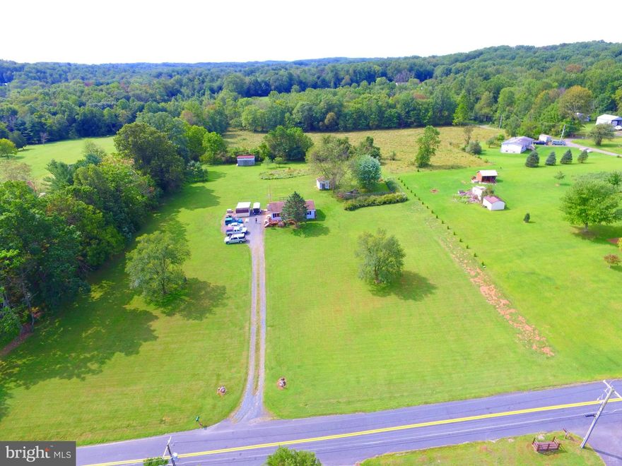 Wow!  Gorgeous 3.18 acre lot surrounded by nature.  Rancher was 3 bedrooms converted to 2 for a large master with double closets.  One floor living with washer/dryer on main level. Freshly painted. New lifeproof luxury vinyl floors in kitchen and bathroom, new vanity in bath, new countertops with white cabinets in eat in kitchen with slider to back deck.  Barn with 2 stalls for horses, 2 storage sheds, decorative Koi pond in fenced area with a firepit.  Large unfinished bathment with extra room for storage, built-in bar area and wood stove waiting for your finishing touches. 2X6 construction makes this home easy to heat and cool.  Handicap accessible with 36" door openings.  Country living at it's best!  Generator excluded and propane tanks will be removed.