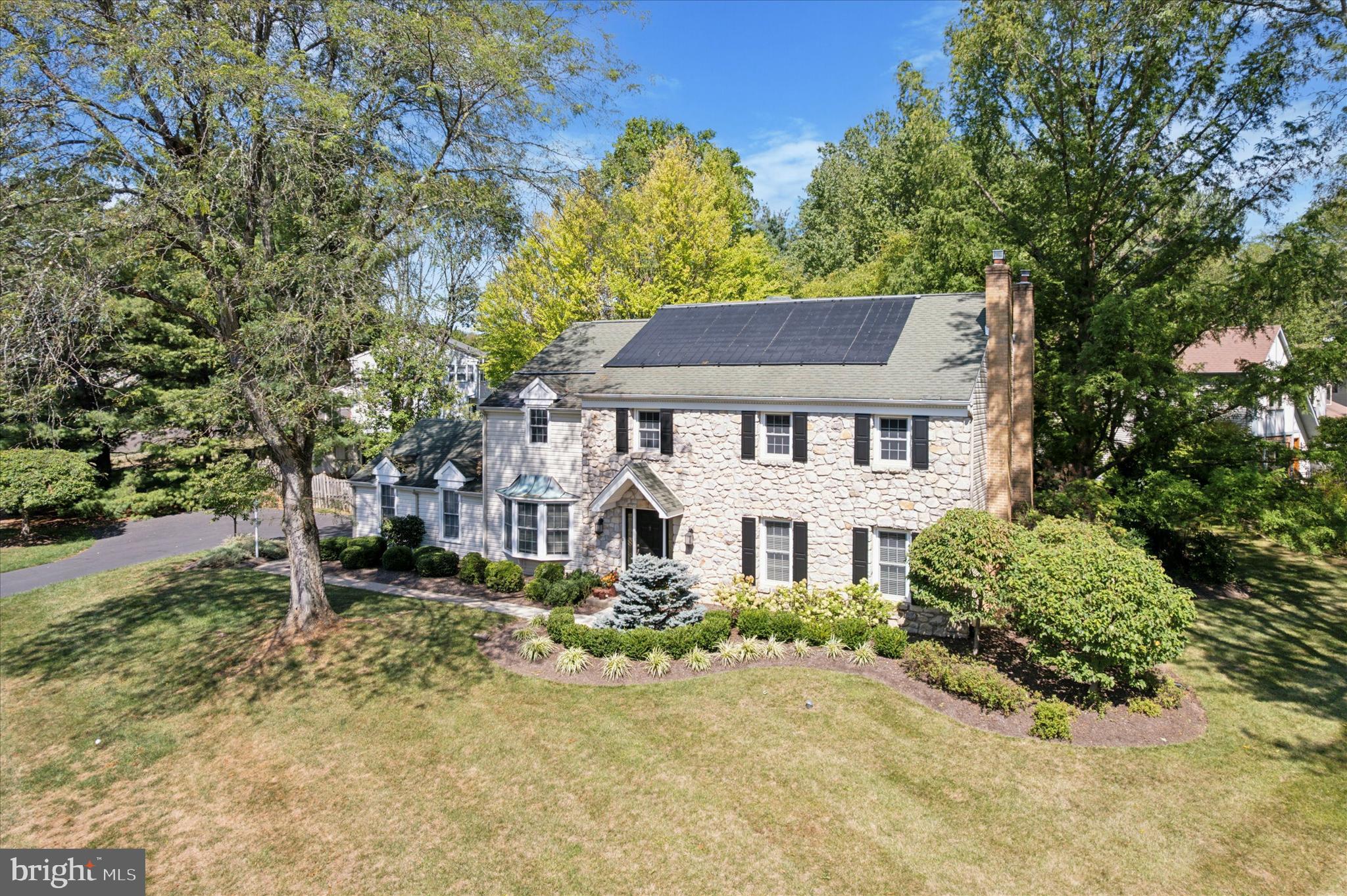 Stunning Center Hall Colonial in Yardley Hunt. Welcome to this beautifully appointed home in the highly sought-after Yardley Hunt community. The inviting foyer, enhanced porcelain flooring and a graceful, turned staircase, offers glimpses of the surrounding rooms. The sunlit formal living room with a decorative fireplace, features French doors that open to the expansive family room, creating a seamless flow for entertaining. The formal dining room, with its gleaming hardwood floors, provides the perfect setting for family gatherings and holiday celebrations. At the heart of the home, the renovated kitchen and family room complement each other with warm tones and thoughtful design. White cabinetry, accented with subway tile and stainless-steel appliances, contrasts beautifully with the darker granite countertops. A center island on the Porcelain floors offers ample workspace and doubles as a perfect buffet area. The family room is anchored by a striking floor-to-ceiling Bucks County Stone hearth gas fireplace, flanked by custom built-in shelving—an inviting and functional focal point. An upgraded powder room and a convenient laundry/mudroom complete the main level. The recently carpeted turned staircase leads to the second floor, where you’ll find a spacious main bedroom retreat. This serene suite includes a large bedroom, a cozy sitting room perfect for unwinding, and an upgraded full bathroom. The bath showcases a contemporary white vanity, a walk-in shower with a seamless glass door, and striking black marble flooring. Three additional well-sized bedrooms share the updated hall bath, offering comfort and style for family or guests. The finished lower level currently houses a home gym but offers a versatile space ready to be transformed into a media room, playroom, or hobby area tailored to your needs. The backyard of this home is truly breathtaking—a private oasis designed for both relaxation and entertainment. Enjoy summers by the sparkling in-ground pool, or the hot tub, or retreat to the separate picnic area, perfect for outdoor dining, evening fires, or even a play space for a jungle gym. The spaces are beautifully connected by a charming boardwalk creating a seamless flow throughout this exceptional outdoor retreat. This home is move-in ready and offers luxurious living for your best summer yet.