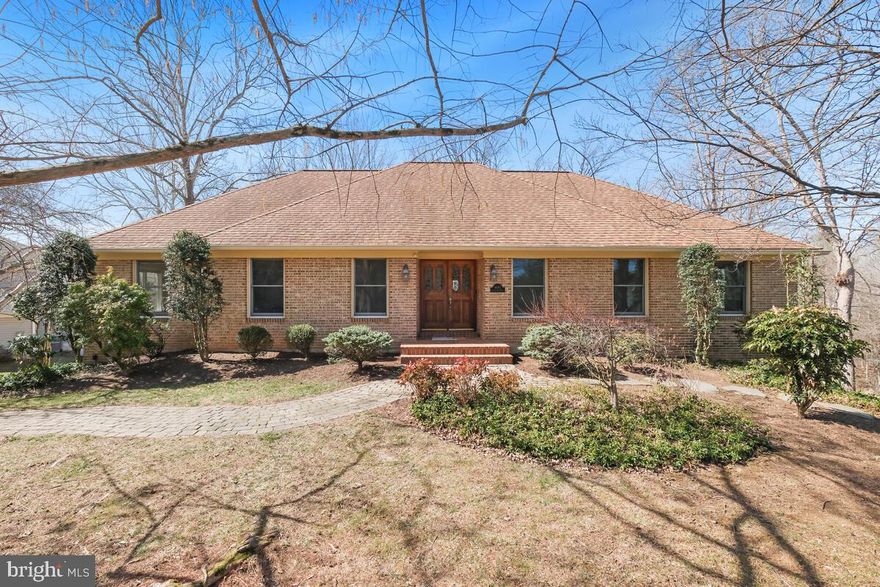 Over 3,000 sq ft!!!  Situated on this 1/2-acre lovely private lot, this spacious, brick-front rambler offers 2 finished levels, with  hardwood flooring  through living and dining rooms. The gorgeous gourmet kitchen (updated in 2013) features heated tile floor a center island, desk alcove, walk-in pantry, and laundry closet with stacked washer dryer and utility sink. Stainless steel appliances include a GE Profile refrigerator/freezer with water/ice dispenser, Bosch dishwasher, Sharp microwave drawer, two GE Profile ovens and a 5-burner gas cooktop, and Broan Elite range hood. also under-cabinet lighting, built-in shelving The spacious family room features a wood-burning fireplace in a brick surround, and 2 Anderson glass doors open to the expansive multi-level deck and screened porch, overlooking trees. The large, main level owner’s suite offers space for sitting area, sliding door to the screened porch, and updated en suite bath with tub, beautiful tiling, separate shower and dual vanities. Two additional bedrooms and a full bath are on this level. The spacious lower, recreation level includes lounge area with gas fireplace, billiards/game area, and custom-designed wet bar with granite counters and disposal. Walk-out via sliding doors to rear patios and the decks above. The home’s 4th bedroom on the lower level can double as a home office, with generous closet space and attached full bath. Additional storage and utility space stands behind the wet bar, as well as in the oversized 2.5 -car garage. All windows are double-pane by Anderson.