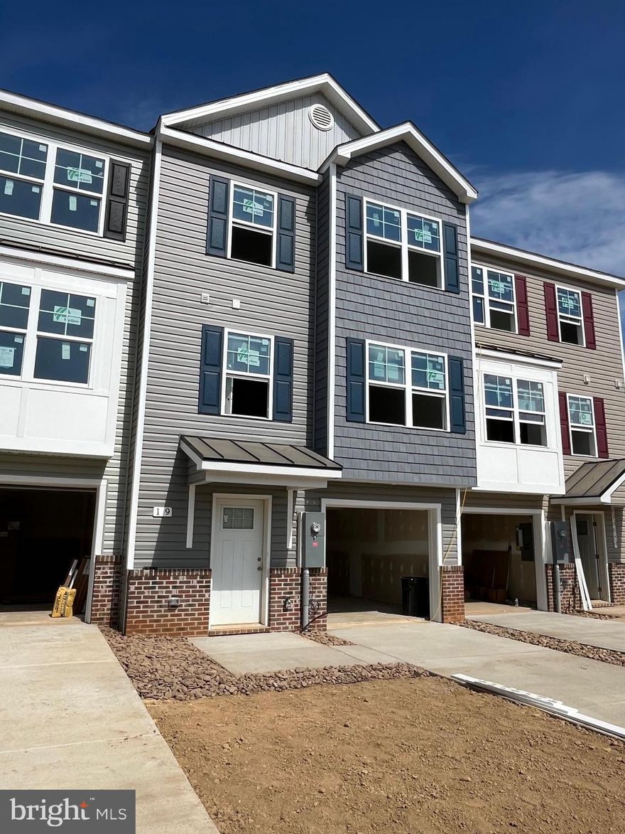 New Town Homes under construction in The Communities of Burwell featuring 1935 sqft of living space. Home has bump outs in main level family room and upper level secondary bedroom, spacious open floor plan, 4 bedrooms/ 3.5 baths, Kitchen with granite countertops, separate island and island bar to family room, stainless steel appliances, and luxury vinyl plank flooring throughout the main level. The upper level primary bedroom has vaulted ceilings, walk in closet, and full bath with tile shower and glass door. The lower level offers 4th bedroom and full bath. Exterior brick on front, 1-car garage with auto opener, and concrete driveway included. **photos are similar construction**