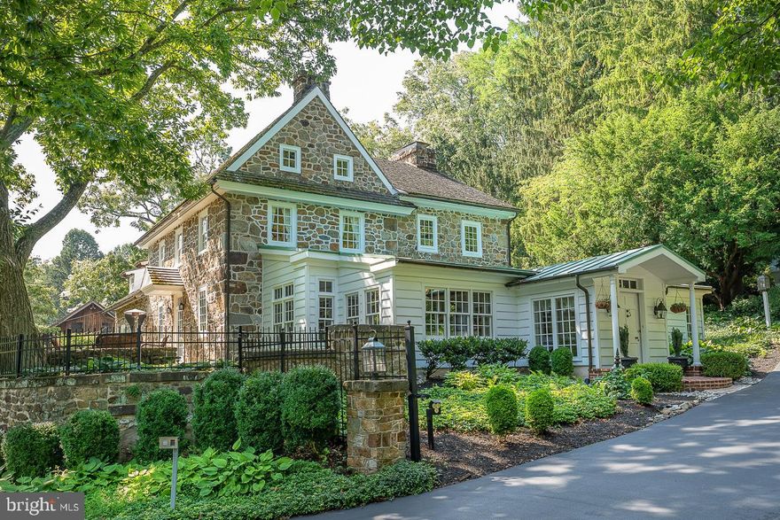 One of the most admired homes in Chester Springs, this magnificent stone home, built in 1740, sits high up on 6.8 acres, consisting of 2 parcels. There is a great sense of privacy, tranquility & history behind the gated entrance, where you will experience a world apart, one of uncompromised taste, charm and quality details in every room. You can expect the unexpected in the flow of rooms, from the front great room with a stunning, entire exposed stone wall, (previously an outside wall) the floor is made from bricks (that have been glazed) from Philadelphia, & includes 3 zone radiant heating. There are 7 heating zones and 3 AC zones. Unlike many older homes, this room, as do most others in this stunning home, offers high vaulted ceilings w/ beams, indirect lighting fixtures and walls of windows that take advantage of the wonderful Southern exposure. The flow for entertaining is fantastic & all of the floors are wide, random width and gleaming.The kitchen, which features high end cabinetry, Bosch, Sub Zero, Thermador & Miele appliances & great storage space, opens to a dining room/ area with fireplace & openings to the fabulous wet bar room, which can easily sit 12+ for an extra dining room…cozy up to the fireplace, enjoy cocktails, or take your morning coffee to the slate terrace & relax under the Chestnut tree! Follow thru to a perfect office space, with walk in fireplace & enjoy overlooking the pool w/hot tub, with beautifully planted brick walkways surrounding the back of the home, plus patio for outdoor living Bonus…the home is Technology savvy! There are 4 corporate grade Wireless Access Points & a Sonos wireless sound system in 5 areas of the home & 1 for the pool area. A beautiful curved stairway takes you to 2-3 charming bdrms on the 2nd flr with 2 enormous custom closets & oversize primary bathroom. Enjoy the sound system in these rooms as well. On the 3rd fl is another bdrm w/vaulted ceiling, beams, beautiful windows with deep window sills & a cedar closet & bathroom; also more floored attic storage space. There really are too many amenities to list…but it certainly includes the 2 bedrm guest house/ cottage/ with sauna, kitchen & bathroom,...all this adding to the living space, plus an extra 2 car attached garage. In addition, the amazing 6-8 car, garage for the main house is any car lovers dream! It is well lit,  controlled for humidity and has rubberized flooring.  Back to the main house, consider the Wood Shake roof, copper gutters and downspouts and the extensive wine cellar as additional commitments to quality, the entire home is in mint condition & so beautifully maintained.! Located in one of the prettiest spots in bucolic Chester County, with its many nature trails & preserves, including the Bryn Coed Trails right nearby, you'll find sophisticated dining at Birchrunville café, or stop by the chic Butterscotch cafe, plus you are only minutes away from Ludwigs Corner& Kimberton. Enjoy the proximity to convenience shopping and at the same time, enjoy the provenance that the history of William Penn provides, which is preserved at 2207 S. Chester Springs Rd….in this rare country side setting, you may even see a horse drawn carriage or two pass by! Come and see why you will want to make 2207 Chester Springs Road your private country estate!