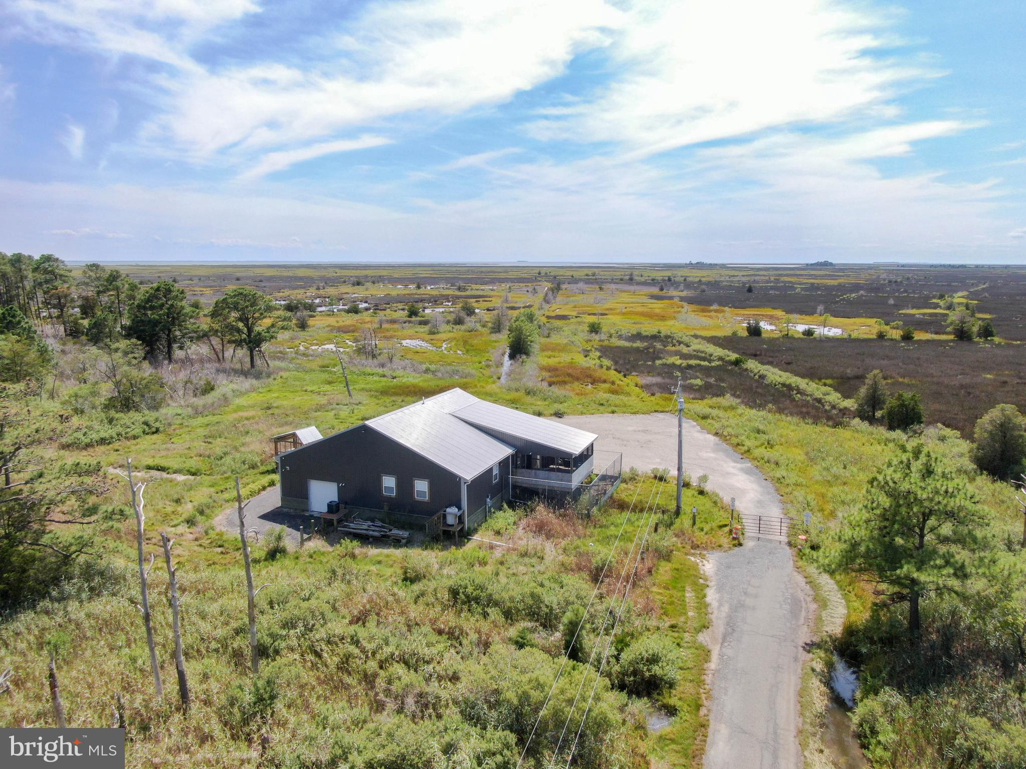 Presenting, Lawson Marsh, Crisfield, Maryland – 1119.42+- acres. The habitat value of Lawson Marsh is significant both today as it was in the mid-1900s when the Ward Brothers were perfecting their decoy carving craft along Jenkins Creek and Lawson Marsh. This property includes a 7.43+- acre parcel on Lloyd Webb Rd featuring a 1,250 sq ft lodge. On the opposite side of the property along the shoreline, the various recreational activities are enhanced through the use of the cabin with pier to access the vast amount of acreage and to extend your stay on the marsh and water, as well as the offshore blind.
The lodge, built in 2020, offers the opportunity for long stays on the property. There is a large, paved parking area to keep your vehicles, including trailers. The three-bedroom lodge provides plenty of sleeping quarters with the existing double beds and bunk beds. The lodge has a screened-in porch, heating and air conditioning, a water treatment system, and washer and drying for all-season use. The lodge is elevated with the garage at ground level. The lodge is being sold furnished including the Evans custom boat, built to navigate shallow water, and Argo.
From the shoreline, there is a large offshore blind, a 115’ perpendicular pier with fish cleaning station where you can tie up to access the cabin. The ground on which the permitted cabin was built was raised 22” and the cabin is elevated on over 6’ pilings and reinforced with hurricane braces. The pilings are enclosed with a single door on one end and a double door on the other end to secure and store equipment. Built approximately 15 years ago, the cabin has a 16’ x 22’ living area, 8’ x 6’ porch with storage closet, and bunk beds to sleep six. There is a permitted composting toilet, propane is brought in for lights, heat, stove, and refrigerator.
The salt marsh has miles of shoreline on Broad Creek, the Little Annemessex River, and through many guts including Landing Gut, Straight Gut, and Massey Creek providing numerous waterways to the interior. The estuarine marsh is characterized by the typical flora that being salt hay (Spartina patens) on the high marsh and cord grass (Spartina alterniflora) on the lower parts of the marsh. A complex of salt marsh ponds dominate the landscape of Lawson Marsh. The salt marsh ponds, together with the complex of creeks and high marsh habitats provide critical wintering habitat to wintering waterfowl throughout the migratory season. The entire shoreline is licensed with DNR for waterfowl hunting. Please see agent for plats.
DO NOT ENTER PROPERTY WITHOUT PERMISSION OF THE LAND GROUP.